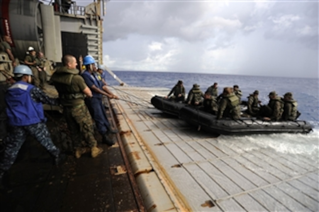 U.S. Navy sailors and Marines recover combat rubber reconnaissance craft manned by Marines assigned to the 31st Marine Expeditionary Unit at the stern gate of the amphibious dock landing ship USS Harpers Ferry (LSD 49) while underway in the Philippine Sea on Sept. 19, 2010.  The Harpers Ferry is on patrol in the western Pacific Ocean as a part of the Essex Amphibious Ready Group, which is participating in Valiant Shield 2010.  The integrated joint-training exercise is designed to enhance interoperability between U.S. forces.  