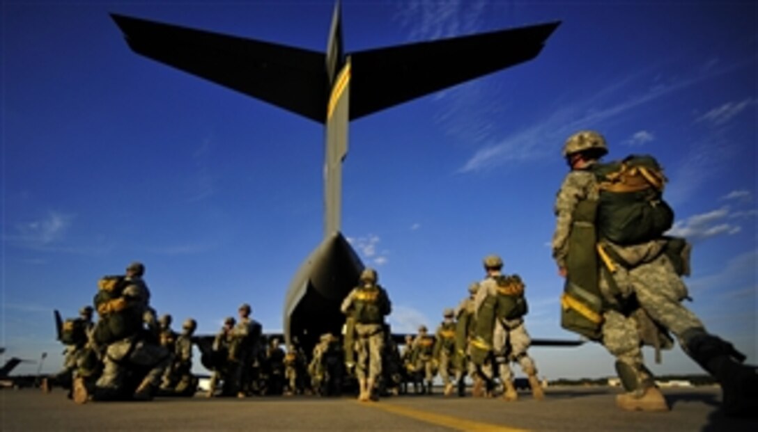 U.S. Army soldiers assigned to the 82nd Airborne Division walk out to a C-17 Globemaster III aircraft prior to a parachute drop during a joint forcible entry exercise at Pope Air Force Base, N.C., on Sept. 14, 2010.  A joint forcible entry training event is held six times a year in order to enhance cohesiveness between the Air Force and the Army.  