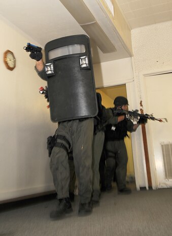 Members of the station’s military police special response team move through the halls of the headquarters building during Exercise Desert Fire, Sept. 21, 2010. The exercise was designed to assess the station’s response to a workplace shooting. The team made its way through the building before coming into the contact with the shooter, who had taken several hostages in the building.
