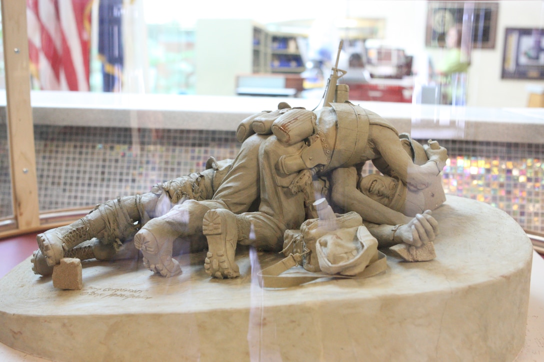 The oil-based clay replica of the planned Corpsmen Memorial sits in the Naval Hospital Camp Lejeune quarterdeck. Abbe Godwin, the sculptor of the bronze Marine at the Beirut Memorial, will create this life-sized Corpsmen Memorial, which will be placed in the Lejeune Memorial Gardens.