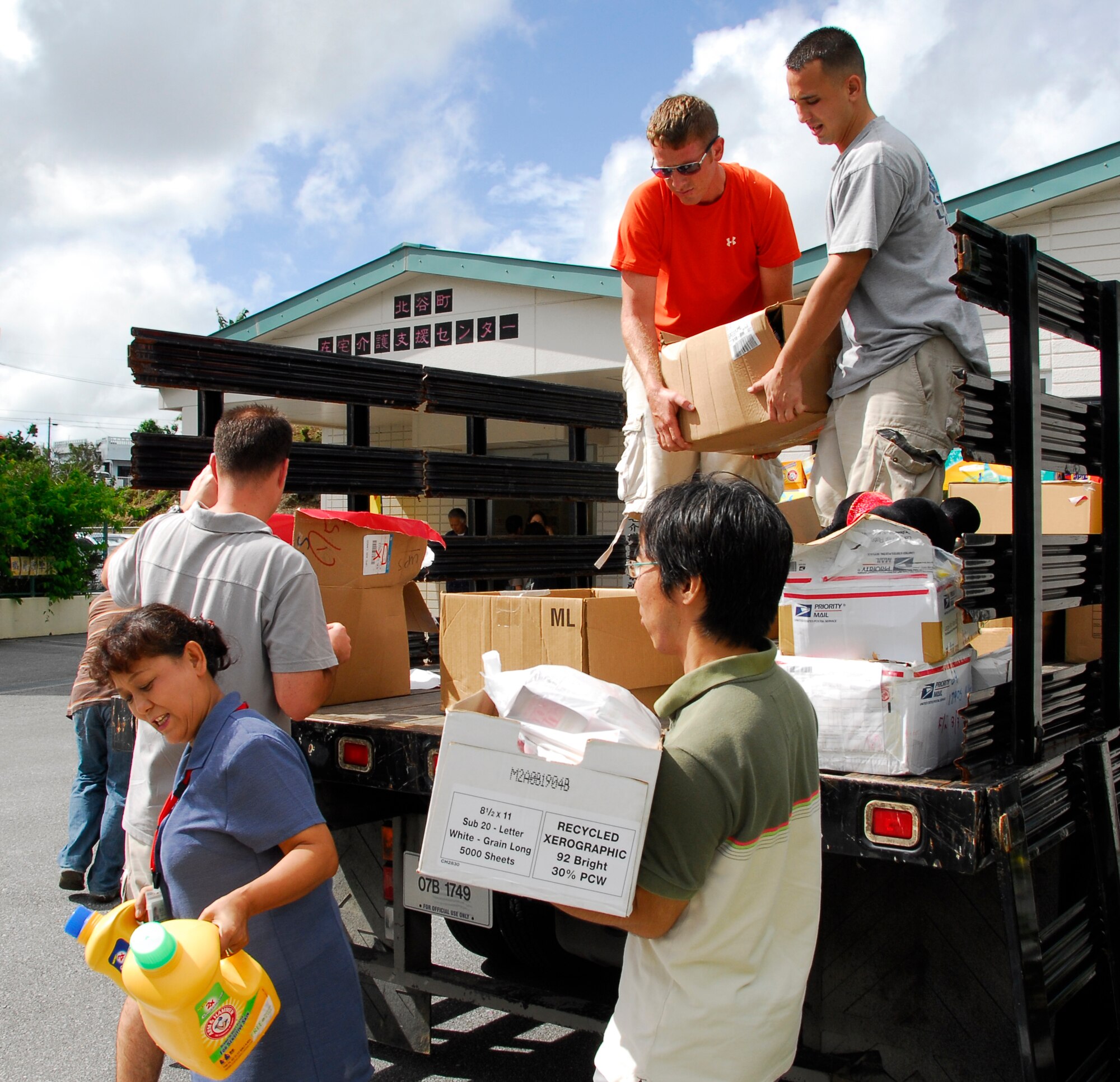 Volunteers unload a truck full of supplies being donated to the Chatan Town Welfare Council Sep. 17. Kadena's Top 3 organization collected donations to help about 200 local families in need. (U.S. Air Force photo/ Airman 1st Class Maeson L. Elleman)