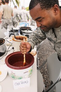 SOTO CANO AIR BASE, Honduras --  Trying to get himself what's left of his chili, Tech. Sgt. Rashaun Monroe, of the 612th Air Base Squadron fire department, realizes there's not much left of the first-place batch after the Air Force Birthday Chili Cook-Off here Sept. 17. The 612th ABS is looking to make the chili cook-off an annual event. (U.S. Air Force photo/Tech. Sgt. Benjamin Rojek)