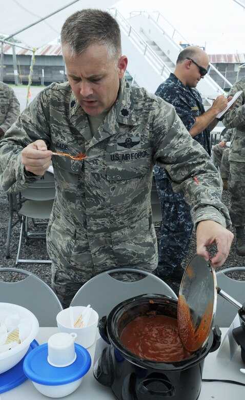 SOTO CANO AIR BASE, Honduras --  Working his way down the line, Lt. Col. David Cade, the 612th Air Base Squadron commander, takes a taste of chili during the Air Force Birthday Chili Cook-Off as Master Chief Shaun Schenkelberg, the finance NCOIC, takes notes here Sept. 17. Almost 10 teams from across Joint Task Force-Bravo entered chilis in the competition, but Tech. Sgt. Rashaun Monroe, of the 612th ABS fire department, took first place. (U.S. Air Force photo/Tech. Sgt. Benjamin Rojek)