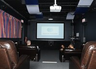 LAUGHLIN AIR FORCE BASE, Texas – Airmen who reside in Laughlin’s enlisted dormitories enjoy the new theater room that was constructed in the dayroom of the dorms here recently. The room contains 13 leather recliners, a high-definition projector with a 120-inch screen, cable, a Blu-ray player and surround-sound. (U.S. Air Force photo by Airman 1st Class Blake Mize) 
