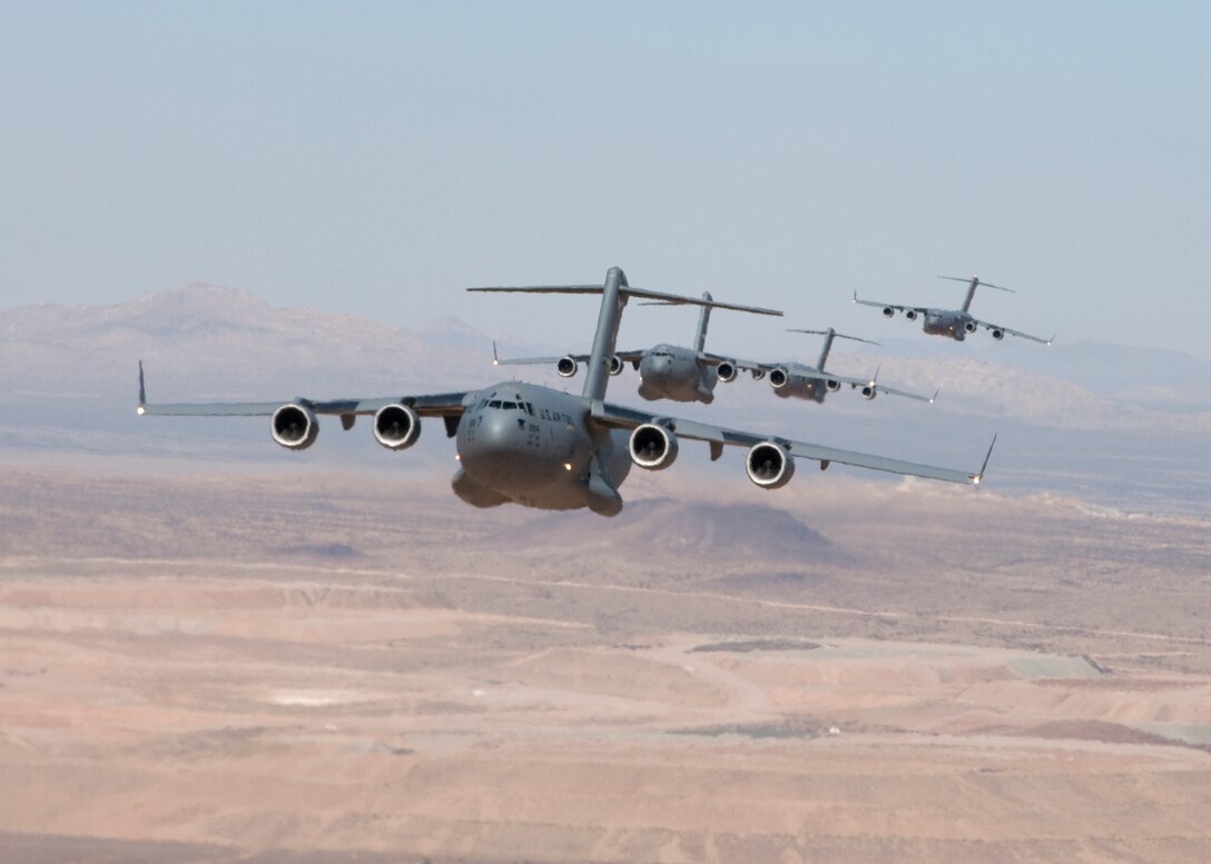 C-17s fly out of Edwards in formation as part of a two-week flight test to validate the C-17 formation flight system.  (Air Force photo by Bobbi Zapka)