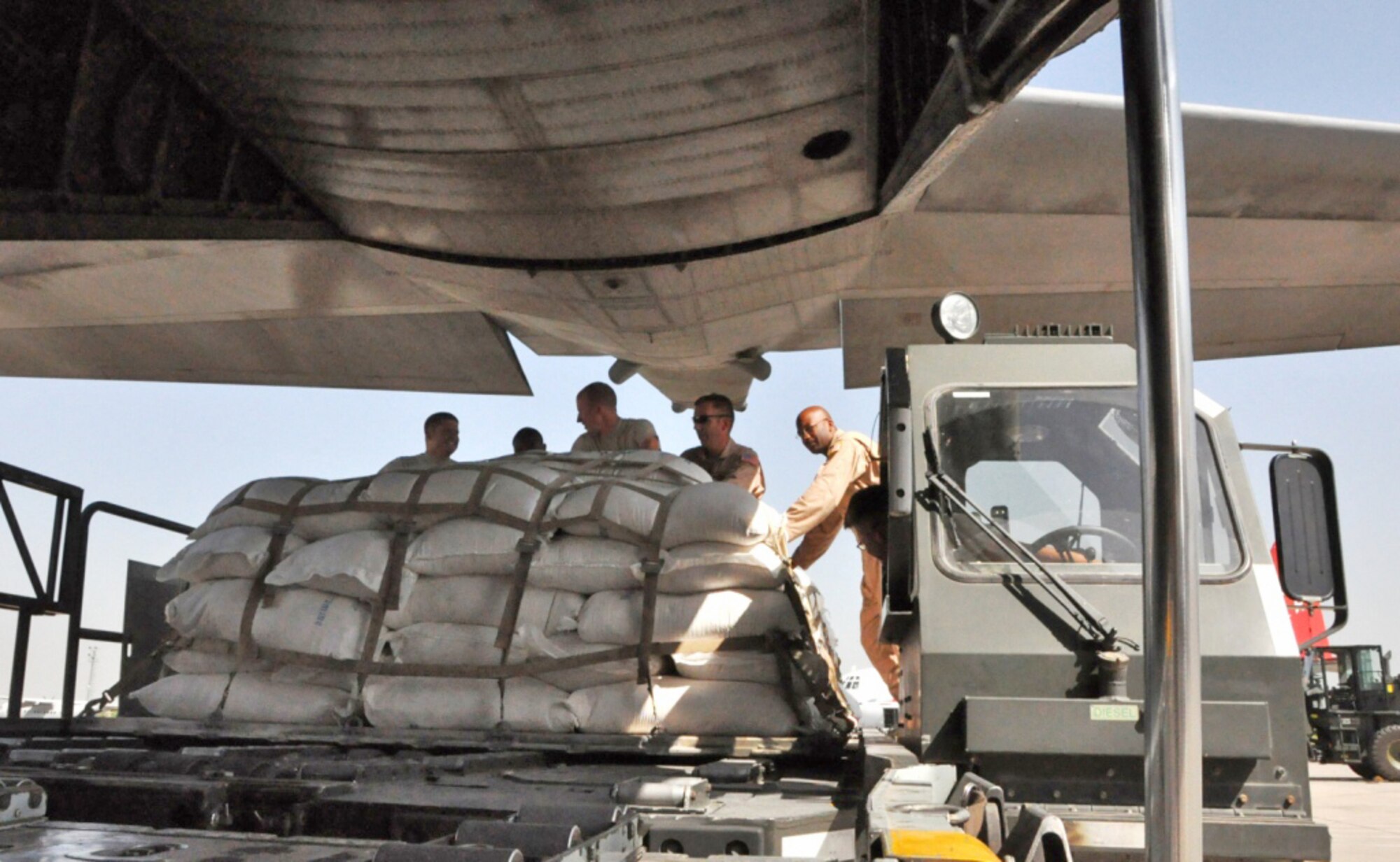 Members of a contingency response element in Pakistan load a C-130 Hercules with pallets of flood relief supplies Sept. 20, 2010, at Pakistan Air Force Base Chaklala. The CRE deployed from the 621st Contingency Response Wing, Joint Base McGuire-Dix-Lakehurst, N.J., to augment operations at the Pakistan air force's Central Flood Relief Cell at the air base. To date, U.S. military personnel and aircraft, working in partnership with the Pakistan military, have delivered more than 3.8 million kilograms of relief supplies and rescued more than 16,000 people throughout the flood-stricken areas of Pakistan. (U.S. Air Force photo/Staff Sgt. Kali L. Gradishar) 