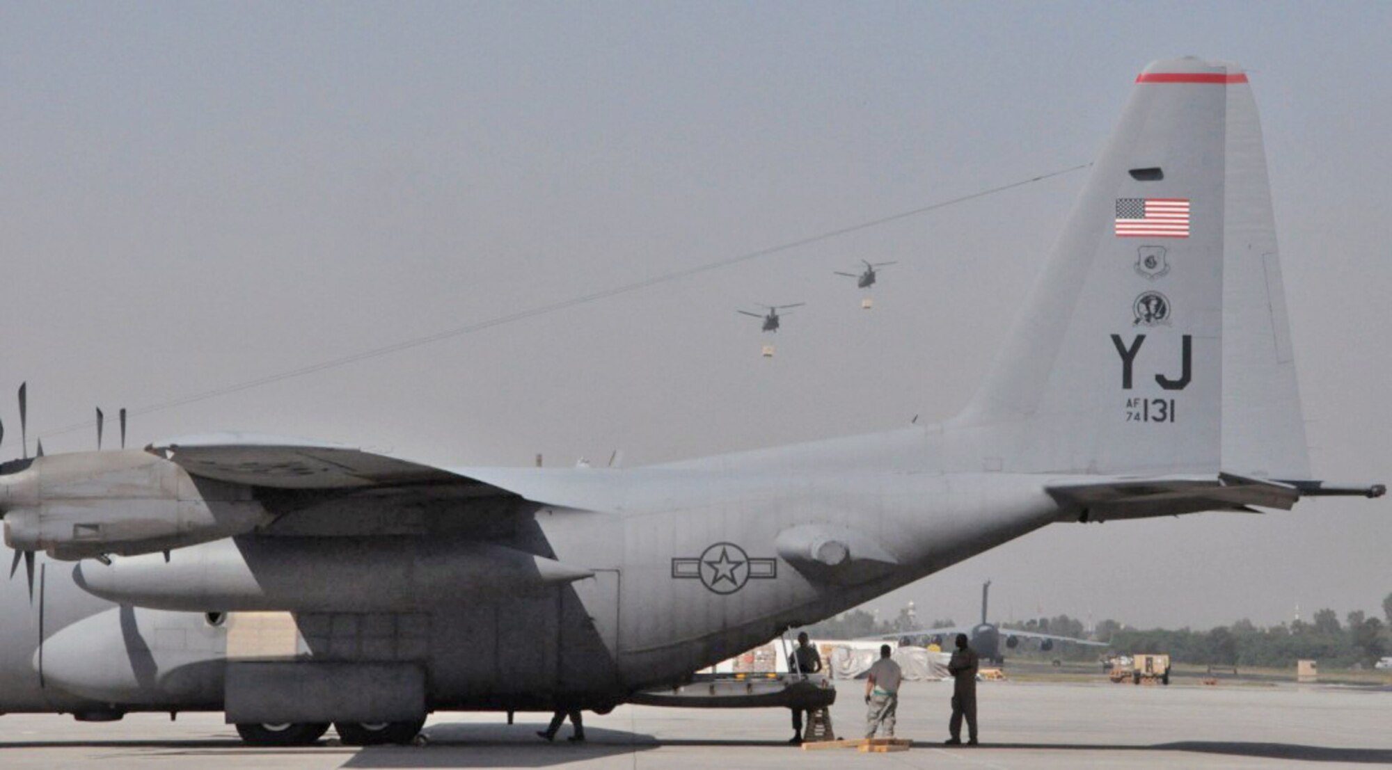Members of a contingency response element in Pakistan prepare for the arrival of flood relief supplies to load a C-130 Hercules Sept. 20, 2010, at Pakistan Air Force Base Chaklala. Airmen deployed from the 621st Contingency Response Wing, Joint Base McGuire-Dix-Lakehurst, N.J., to augment operations at the Pakistan air force's Central Flood Relief Cell at the air base. To date, U.S. military personnel and aircraft, working in partnership with the Pakistan military, have delivered more than 3.8 million kilograms of relief supplies and rescued more than 16,000 people throughout the flood-stricken areas of Pakistan. (U.S. Air Force photo/Staff Sgt. Kali L. Gradishar) 
