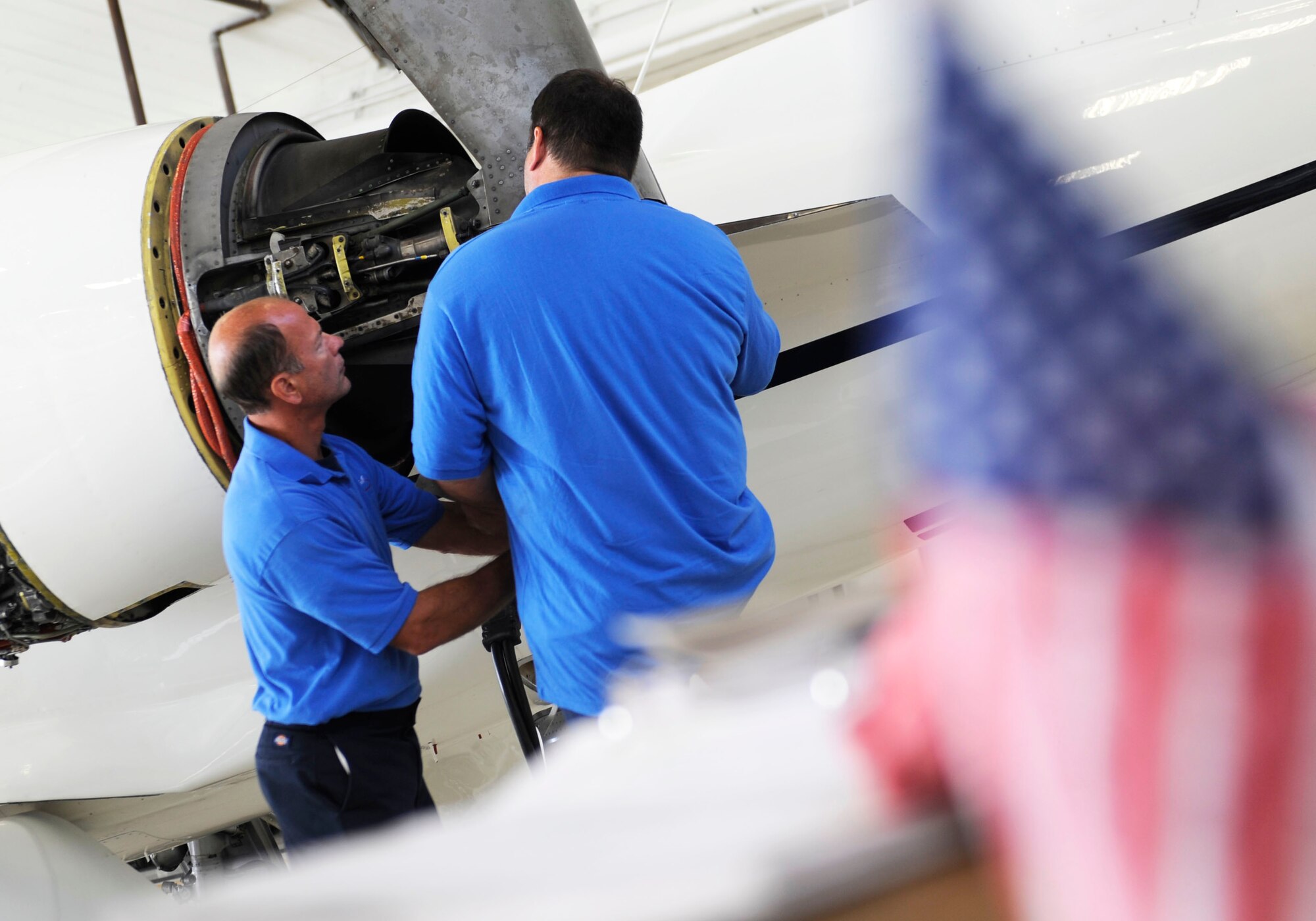 SCOTT AIR FORCE BASE, Ill. -- Eric Bollinger and Bob Norrenberns, both DynCorp International contractors, works on a C-21 during a phase inspection at Scott Sept. 16.  The phase inspections are done on aircraft after they reach flying milestones to ensure the aircraft remain in top condition. (U.S. Air Force photo by Staff Sgt. Brian J. Valencia)