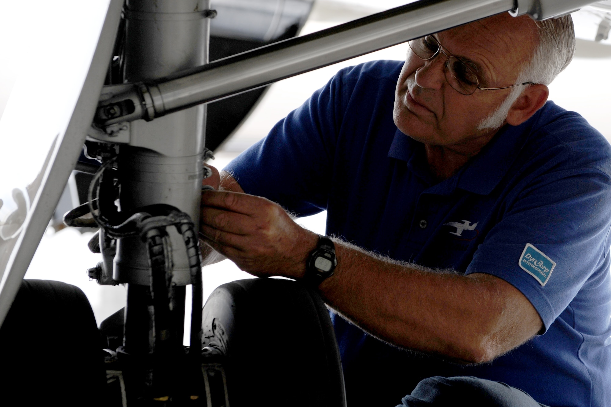 SCOTT AIR FORCE BASE, Ill. -- Dan Arens, DynCorp International contractor, performs maintenance on a C-21 landing gear during a phase inspection at Scott AFB, Sept. 15, 2010. The phase inspections are done on aircraft after they reach flying milestones to ensure the aircraft remain in top condition. (U.S. Air Force photo by Staff Sgt. Brian J. Valencia)