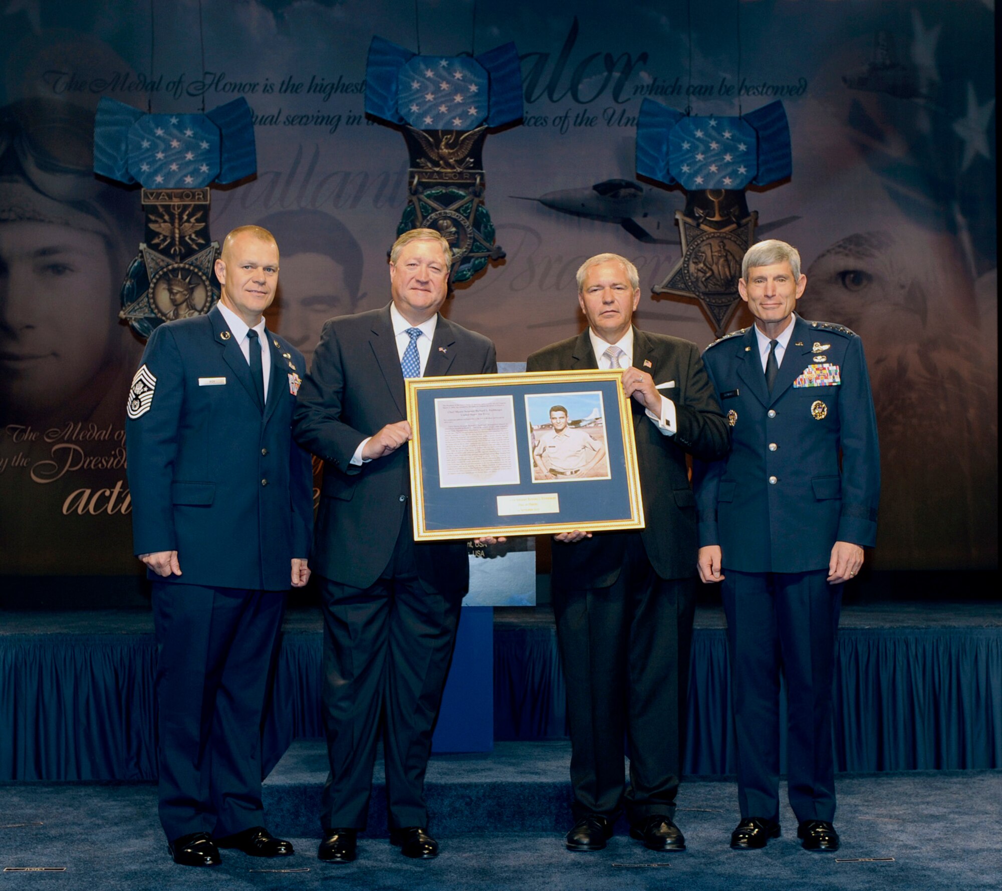 (From left) Chief Master Sgt. of the Air Force James A. Roy, Secretary of the Air Force Michael Donley, Cory Etchberger, son of Medal of Honor recipient Chief Master Sgt. Richard L. Etchberger, and Air Force Chief of Staff Gen. Norton Schwartz display a framed copy of Chief Etchberger's Medal of Honor citation during a Pentagon Hall of Heroes induction ceremony Sept. 22, 2010, in the Pentagon. (U.S. Air Force photo/Andy Morataya)