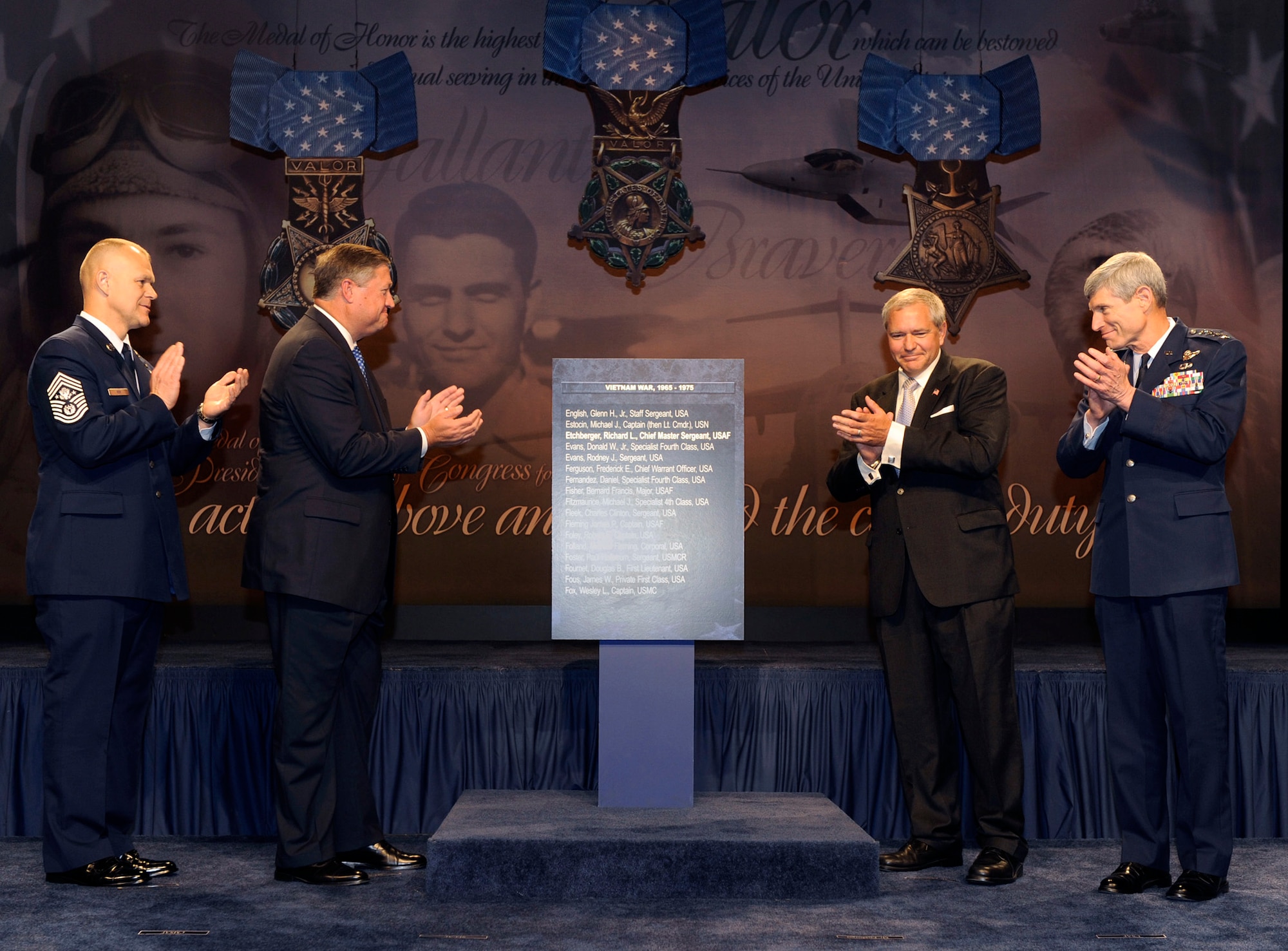 (From left) Chief Master Sgt. of the Air Force James A. Roy, Secretary of the Air Force Michael Donley, Cory Etchberger, son of Medal of Honor recipient Chief Master Sgt. Richard L. Etchberger, and Air Force Chief of Staff Gen. Norton Schwartz unveil the new Pentagon Hall of Heroes wall panel adding Chief Etchberger's name during an induction ceremony Sept. 22, 2010, in the Pentagon. (U.S. Air Force photo/Andy Morataya)