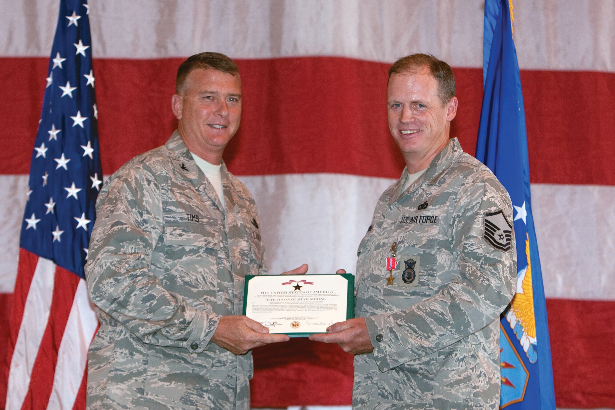 Master Sgt. Michael Blackwell, 90th Security Support Squadron is awarded a Bronze Star by Col. Greg Tims, 90th Missile Wing commander Sept. 19 in building 1501. Master Sgt. Blackwell served in operation IRAQI FREEDOM 2009-2010, he participated in more than 300 combat missions and travelled more then 13,000 miles building relations with the Iraqi citizens and their police force. (U.S. Air Force photo by Jeff Allred)