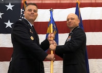 MINOT AIR FORCE BASE, N.D. -- Lt. Col. James C. Lowe assumes command of the 791st Missile Security Forces Squadron shown here taking the guidon from Col. James A Carroll, 91st Security Forces Group commander, Sept. 20. The 791st MSFS provides security forces for secure escort, unauthorized access denial and hostile recapture when needed for the 91st Missile Wing's 150 ICBMs, their launch facilities and 15 missile alert facilities spread across 8,500 square miles of Northwest North Dakota. The 91st MW is an integral member of Air Force Global Strike Command. (U.S. Air Force photo by Airman 1st Class Aaron-Forrest Wainwright)