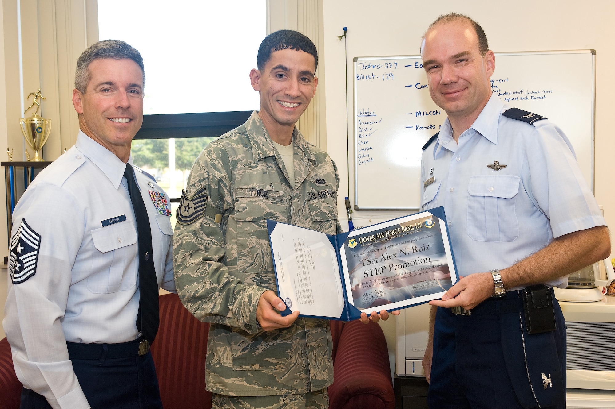 Staff Sgt. Alex Ruiz receives a promotion to Technical Sergeant from Col. Manson Morris, 436th Airlift Wing commander, and Chief Master Sgt. David Spector, Command Chief Master Sgt. for Air Mobility Command, at the telephone shop, Building 302, on Dover Air Force Base, Del., Sept. 20, 2010. Tech. Sgt. Ruiz earned his promotion through the Stripes for Exceptional Performers program (STEP). (U.S. Air Force photo by Roland Balik/Released)