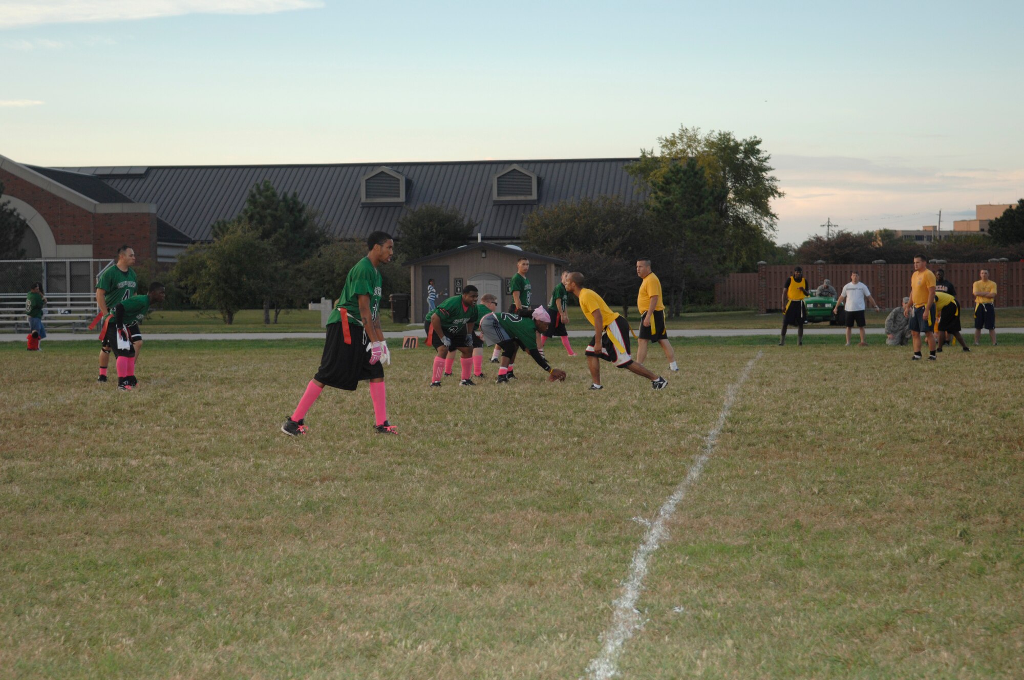 SCOTT AIR FORCE BASE, Ill. -- Patrick Jones, the 635th Supply Chain Operations Group flag football team center, hikes the football during a game against the 375th Communications Squadron at the James Gym Track. The 635th SCOG flag football players collect funds during every game to donate money in support of cancer. (U.S. Air Force photo/Senior Airman Amber R. Kelly-Herard)