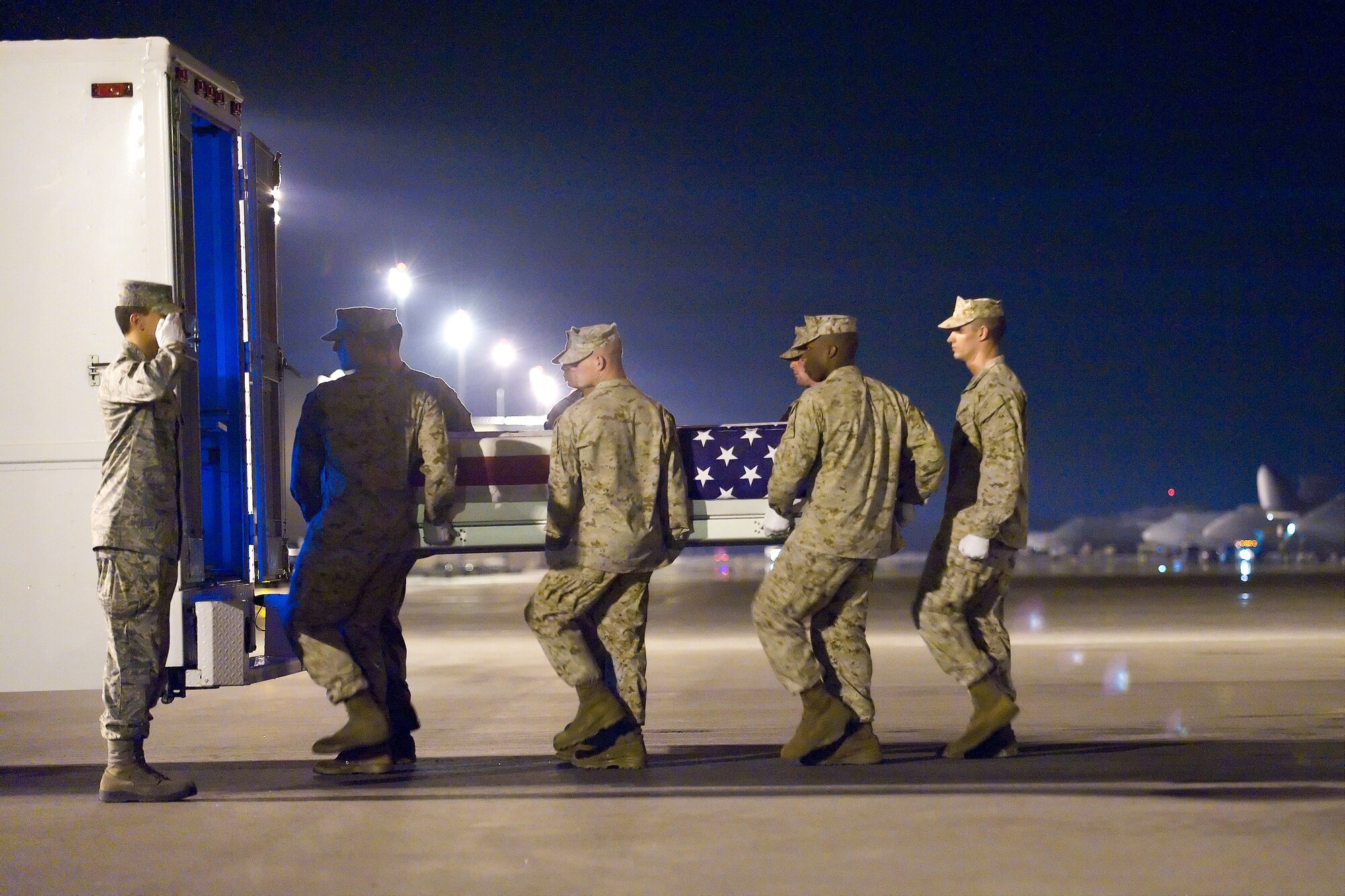 A U.S. Marine Corps team transfers the remains of Marine Corps Sgt. Joseph A. Bovia, of Kenner, La., at Dover Air Force Base, Del., Sept. 3, 2010. Bovia was assigned to the 3rd Combat Assault Battalion, 3rd Marine Division, III Marine Expeditionary Force, Okinawa, Japan.  (U.S. Air Force photo/Roland Balik)