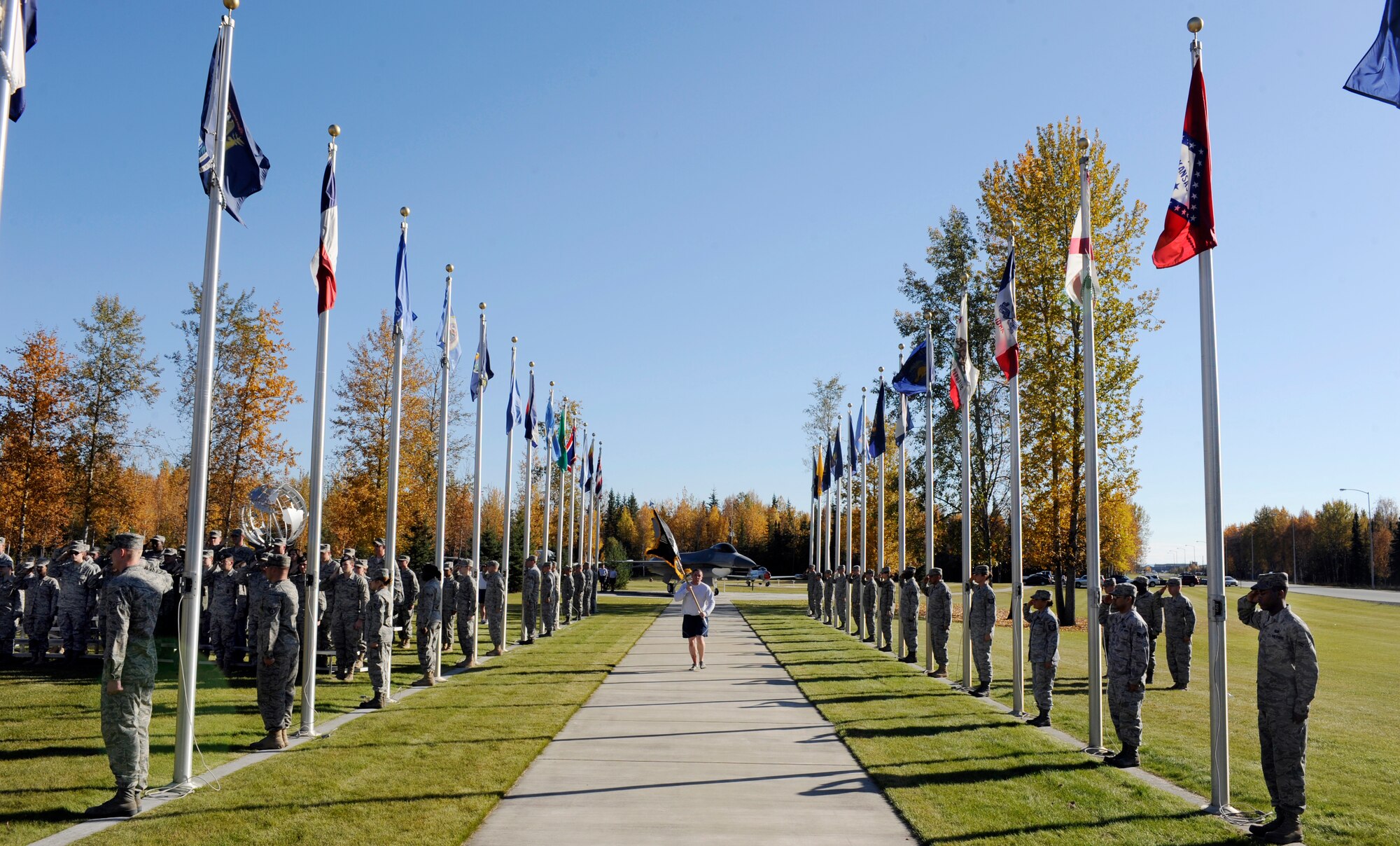 A member of the 354th Fighter Wing runs the Prisoners of War flag home Sept. 17, 2010, Eielson Air Force Base, Alaska. The flag is representative of the Prisoners of War/Missing in Action. The ceremony commemorates troops captured and missing in war. (U.S. Air Force photo/Senior Airman Willard E. Grande II)