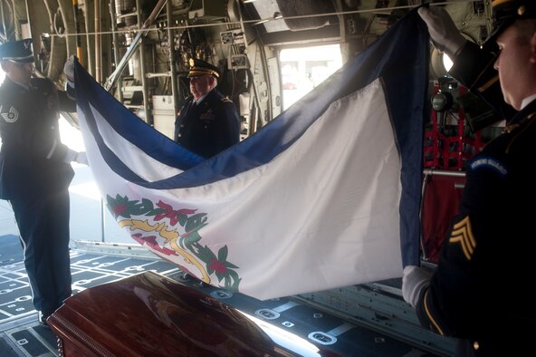 West Virginia State Adj. Gen. Allen E. Tackett, center, stands watch over Sen. Robert C. Byrd’s casket, July 2, 2010, aboard a C-130H3 Hercules aircraft of the 130th Airlift Wing, West Virginia Air National Guard. Master Sgt. Anthony E. Hill, left, supervisory supply technician with the 130th Logistics Readiness Squadron, 130th AW and Army Sgt. Joshua Rife, right, a fulltime honor guard member with the West Virginia Army National Guard, fold the West Virginia state flag in preparation for the departure of Sen. Byrd’s remains back to Andrews Air Force Base, Md.U.S. Air Force photo by Tech. Sgt. Andrew M. Lamoreaux/Released