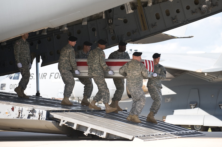 A U.S. Army carry team transfers the remains of Army Pfc. Diego M. Montoya, of San Antonio, Texas, at Dover Air Force Base, Del., Sept. 4, 2010.  Montoya was assigned to the 720th Military Police Battalion, 89th Military Police Brigade, Fort Hood, Texas. (U.S. Air Force photo/Roland Balik)