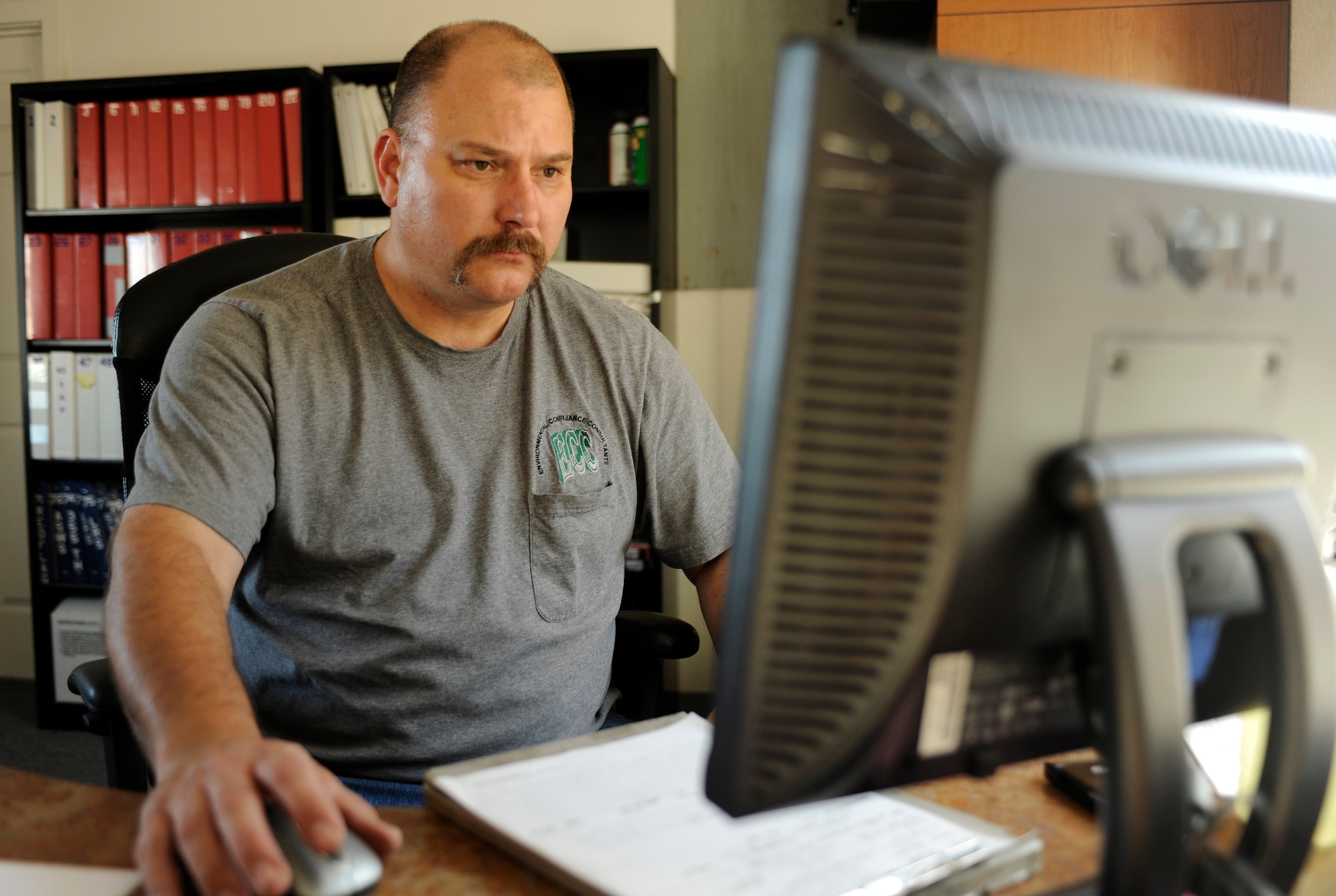 Richard Bealer logs entries into a computer Sept. 15, 2010, Eielson Air Force Base, Alaska. Mr. Bealer logs all new deliveries into a system for continuity. Mr. Bealer is a Material Handler for Environmental Compliance Consultants. (U.S. Air Force photo/Senior Airman Willard E. Grande II)
