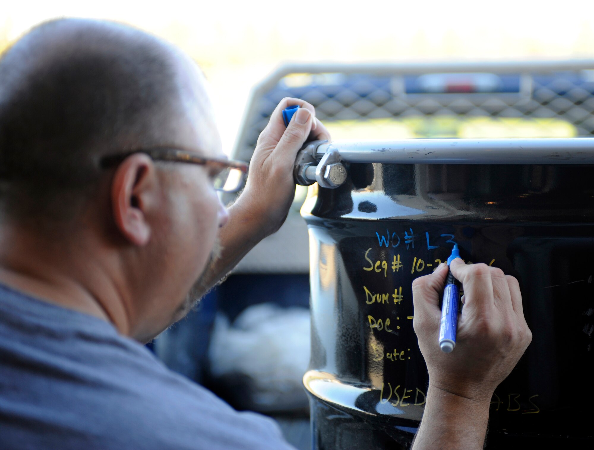 Richard Bealer marks a pickup Sept. 15, 2010, Eielson Air Force Base, Alaska. Mr. Bealer marks all pickups so he can track units output of hazardous material. Mr. Bealer is a Material Handler for Environmental Compliance Consultants. (U.S. Air Force photo/Senior Airman Willard E. Grande II)