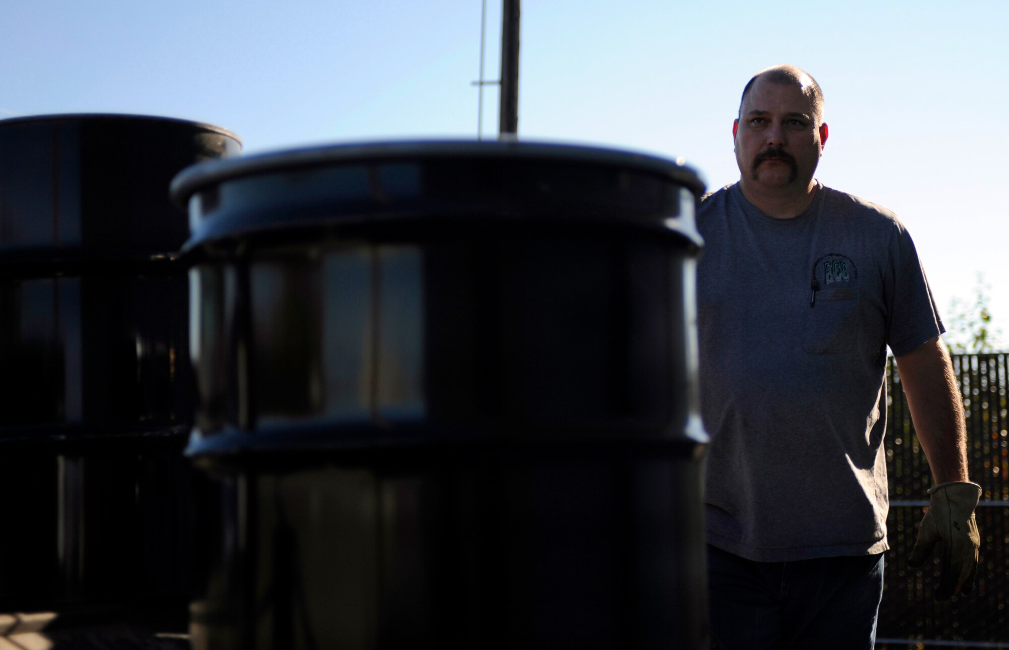 Richard Bealer loads empty drums into his truck Sept. 15, 2010, Eielson Air Force Base, Alaska. Mr. Bealer replaces individual unit's full drums with empty ones. Mr. Bealer is a Material Handler for Environmental Compliance Consultants. (U.S. Air Force photo/Senior Airman Willard E. Grande II)