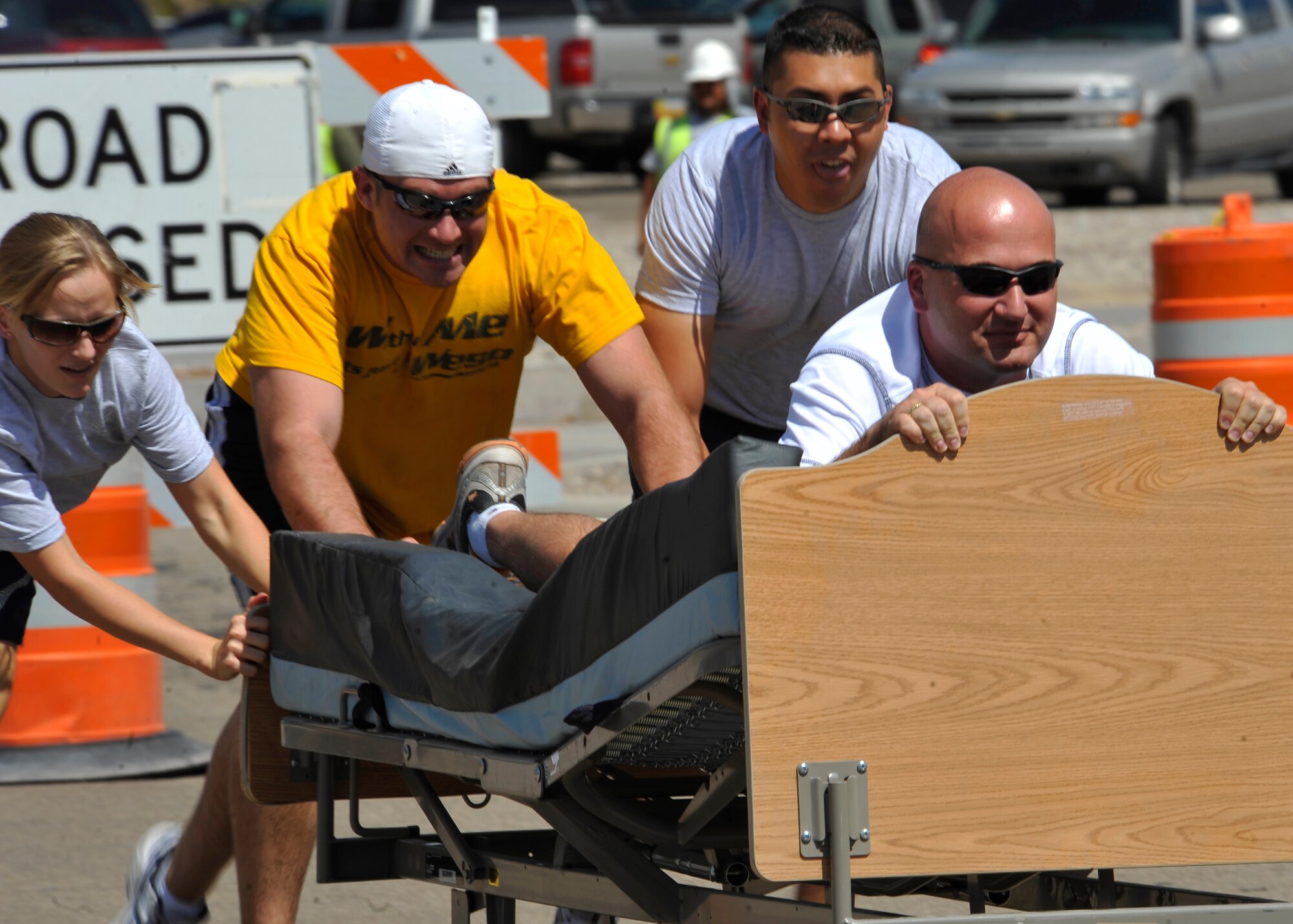 HOLLOMAN AIR FORCE BASE, N.M. -- Senior Master Sgt. Willis Nelson, 49th Operation Support Squadron, lies on a bed while his teammates race to the finish line during the Bed Race on Sports Day, Sept. 17, 2010. Airmen from different squadrons competed in bed races that required four team members to quickly zig-zag through orange cones and run straight back to the finish line. (U.S. Air Force photo by Senior Airman Veronica Stamps / Released) 
