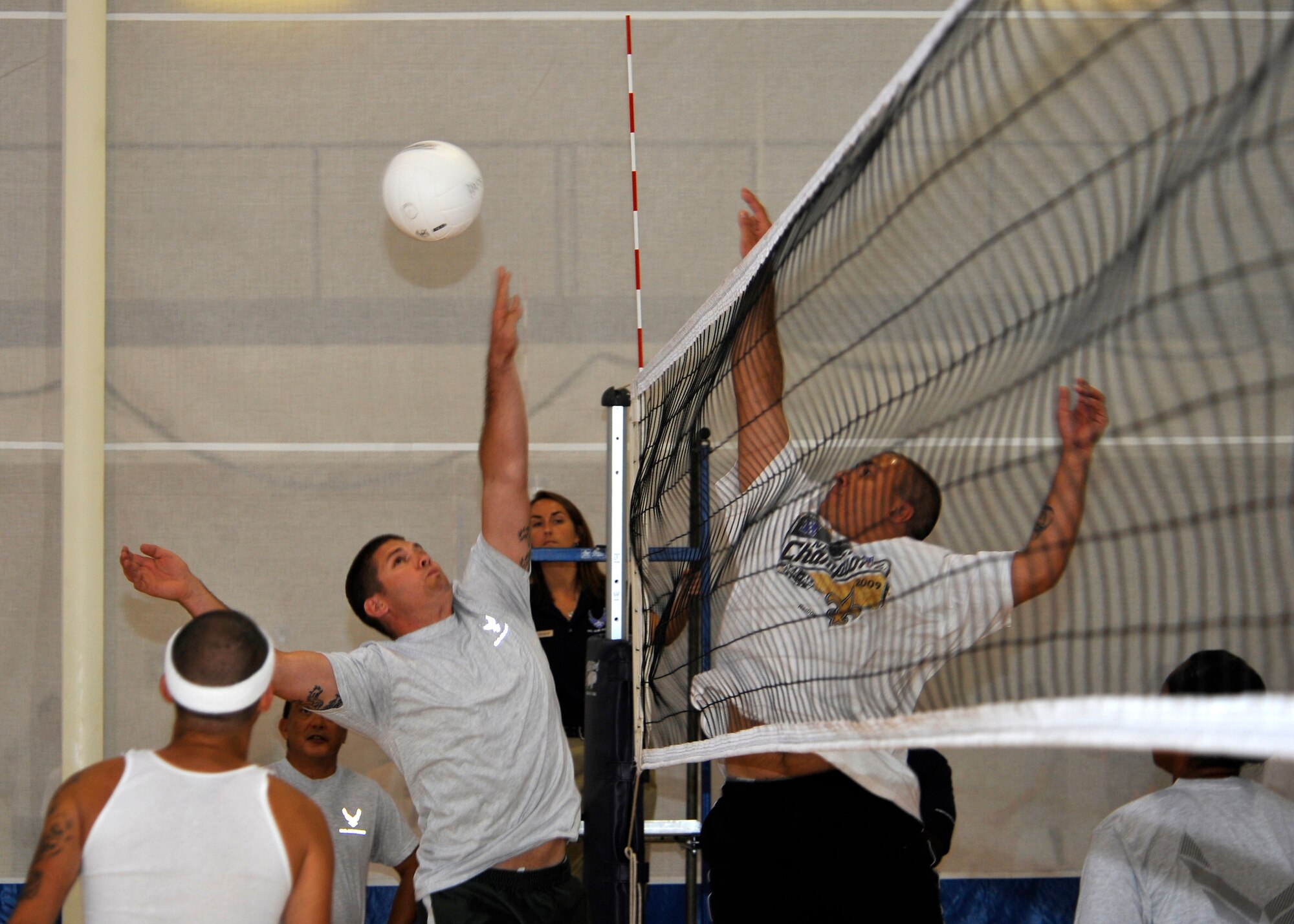 HOLLOMAN AIR FORCE BASE, N.M. -- Airmen from the 849th Aircraft Maintenance Squadron and the 49th Operation Support Squadron compete in a volleyball game during Sports Day, Sept. 17, 2010. Airmen from different squadrons started off the sporting events with a Wing fun run, followed by other activities such as basketball, racquetball and bowling. (U.S. Air Force photo by Senior Airman Veronica Stamps / Released)