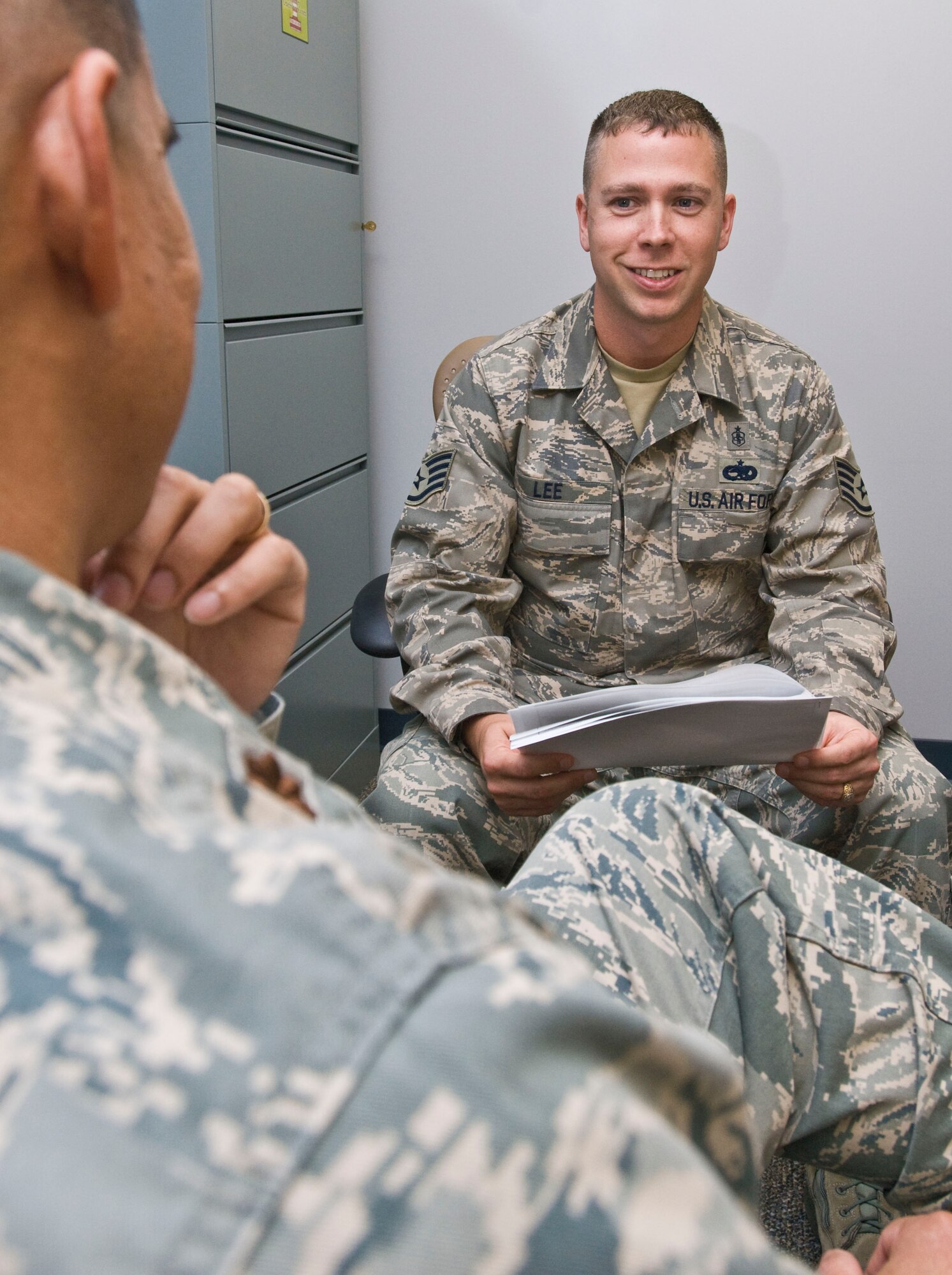 Staff Sgt. Samuel Lee, 19th Medical Operations Squadron mental health clinic NCO-in-charge, reviews the Health Services Inspection and Accredited Association for Ambulatory Health Care Inspection schedules Sept. 20 with Maj. Allan Bigtas, 19th MDOS mental health flight commander. The Byhalia, Miss., native helped launch a Department of Defense predeployment traumatic brain injury screening program and completed more than 900 tests resulting in zero deployment delays. (U.S. Air Force photo by Staff Sgt. Nestor Cruz)