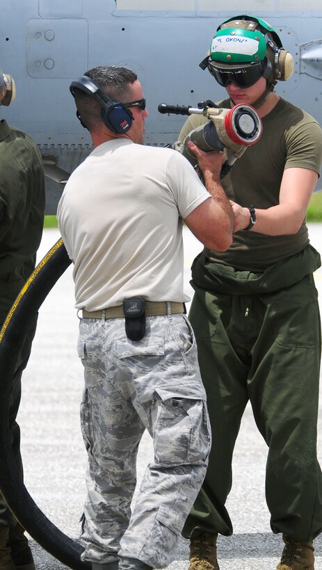 Members of the 36th Logistics Readiness Squadron and Marine Wing Support Squadron 171 perform a hotpit refuel on an F/A 18 Delta Hornet during Valiant Shield 2010 Sept. 14, 2010, at Andersen Air Force Base, Guam. Valiant Shield is an integrated joint training and interoperability exercise among U.S. military forces. (U.S. Air Force photo by Airman Julian North)