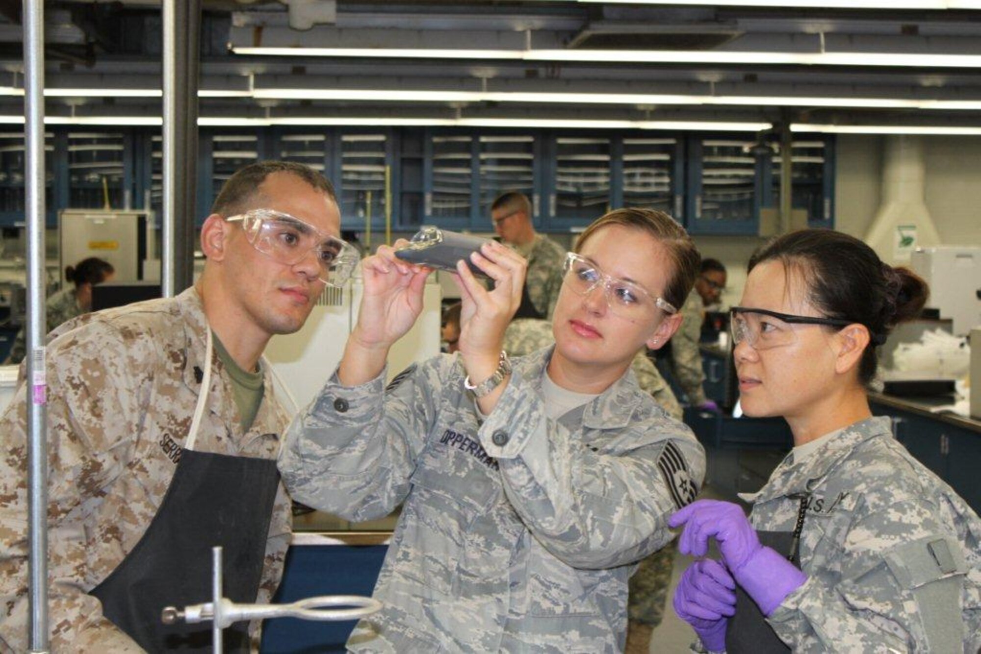 Tech. Sgt. Kara Opperman (center) instructs her students on quality control techniques at the 364th Training Squadron Operating Location B at Fort Lee, Va.  Sergeant Opperman, Service Petroleum Laboratory Course instructor, recently earned the Army Quartermaster School’s Distinguished Instructor Award and will be competing to be named the Army Training and Doctrine Instructor of the Year.  (U.S. Air Force courtesy photo)