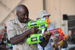Master Sgt. Stephen Wilkerson fires away at other wing members during the combat dining out on Joint Base Charleston, S.C., Sept. 17, 2010. The combat dining out encouraged a casual atmosphere of fun, and Sergeant Wilkerson took full advantage, blasting away at opponents and dodging streams of water to stay high and dry. Sergeant Wilkerson is the 437th Maintenance Operation Squadron first sergeant. (U.S. Air Force photo/James M. Bowman)(Released)