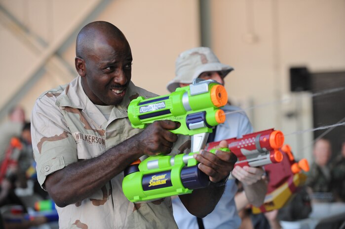 Master Sgt. Stephen Wilkerson fires away at other wing members during the combat dining out on Joint Base Charleston, S.C., Sept. 17, 2010. The combat dining out encouraged a casual atmosphere of fun, and Sergeant Wilkerson took full advantage, blasting away at opponents and dodging streams of water to stay high and dry. Sergeant Wilkerson is the 437th Maintenance Operation Squadron first sergeant. (U.S. Air Force photo/James M. Bowman)(Released)