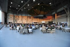 Members of the 437th Airlift Wing await the start of the combat dining out on Joint Base Charleston, S.C., Sept. 17, 2010. The event ran well into the evening, providing food and fun for service members and promoting esprit de corps. (U.S. Air Force photo/James M. Bowman)(Released)
