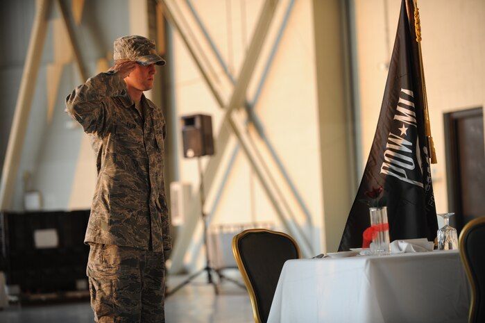 Members of the 437th Airlift Wing engage in a water gun fight during the combat dining out on Joint Base Charleston, S.C., Sept. 17, 2010. Two members provided cover with a folding table while the other took aim against their adversaries on the opposite side of the hangar. (U.S. Air Force photo/James M. Bowman)(Released)