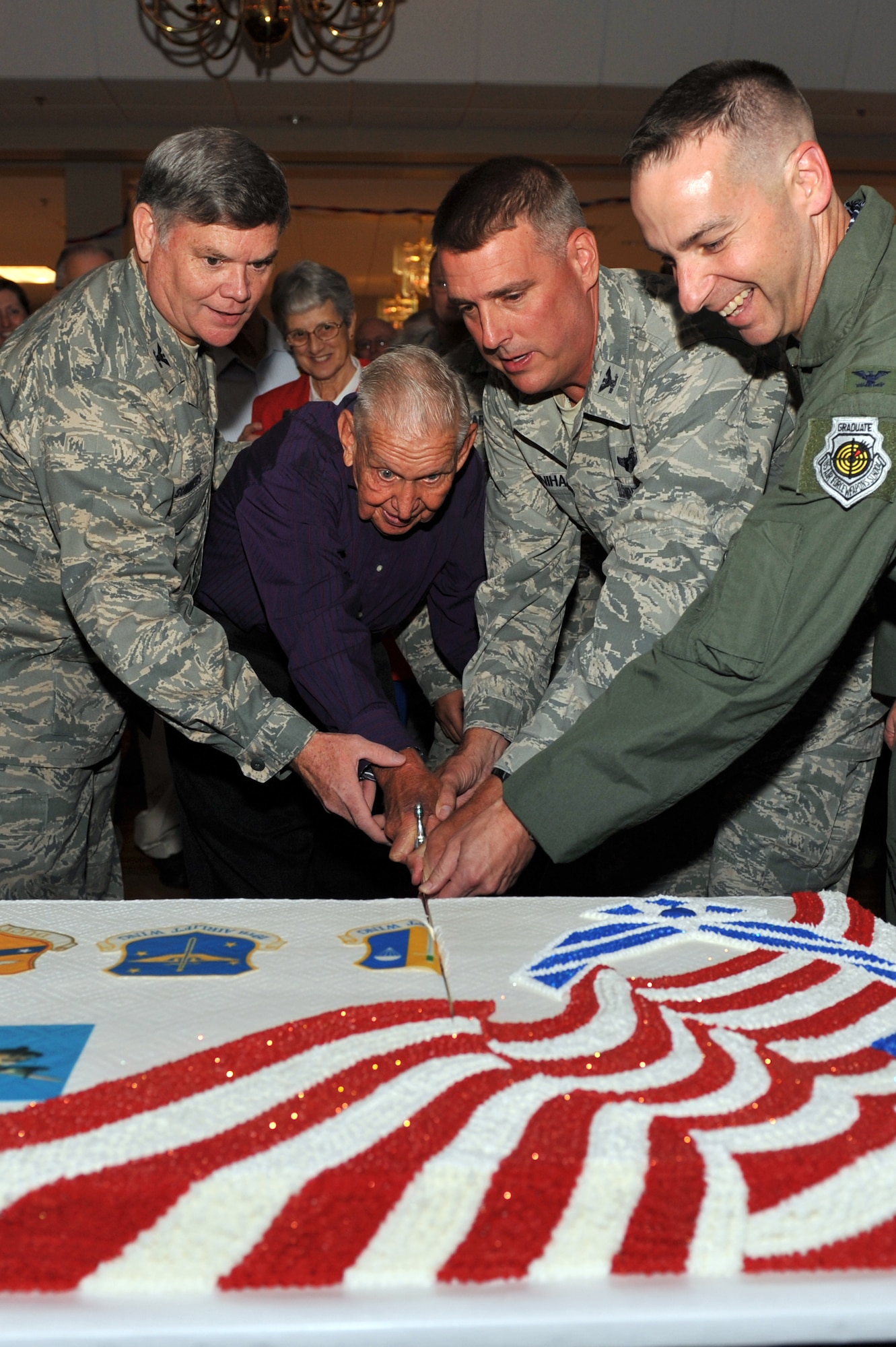 Col. James Summers, 189th Airlift Wing commander; Retired Brig. Gen. Oliver Myers, 61st Airlift Squadron honorary commander; Col. Mike Minihan, 19th Airlift Wing commander; and Col. Mark Czelusta, 314th Airlift Wing commander; use an honor guard sword Sept. 18 to cut the Air Force Birthday cake. Little Rock Air Force Base hosted the 63rd Annual Air Force birthday bash at Hanger 1080. (U.S. Air Force photo by Staff Sgt. Chris Willis)