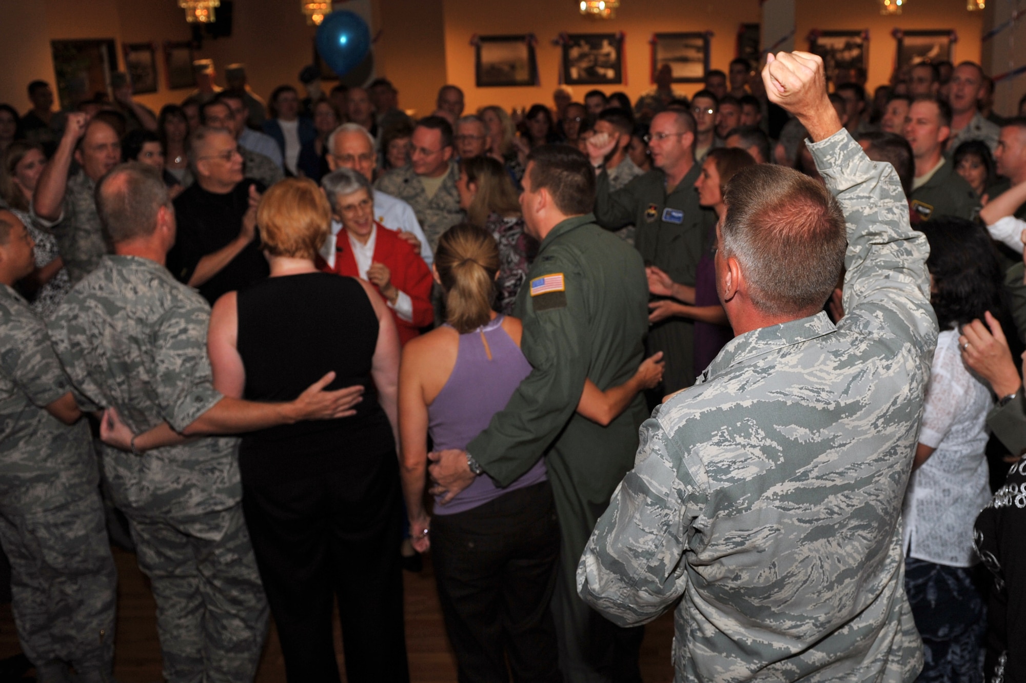 Col. Mike Minihan, 19th Airlift Wing commander, leads the crowd during the singing of the Air Force song at the Sept. 18 Air Force birthday bash. More than 245 Team Little Rock members attended the Air Force Ball hosted at Hanger 1080. (U.S. Air Force photo by Staff Sgt. Chris Willis)