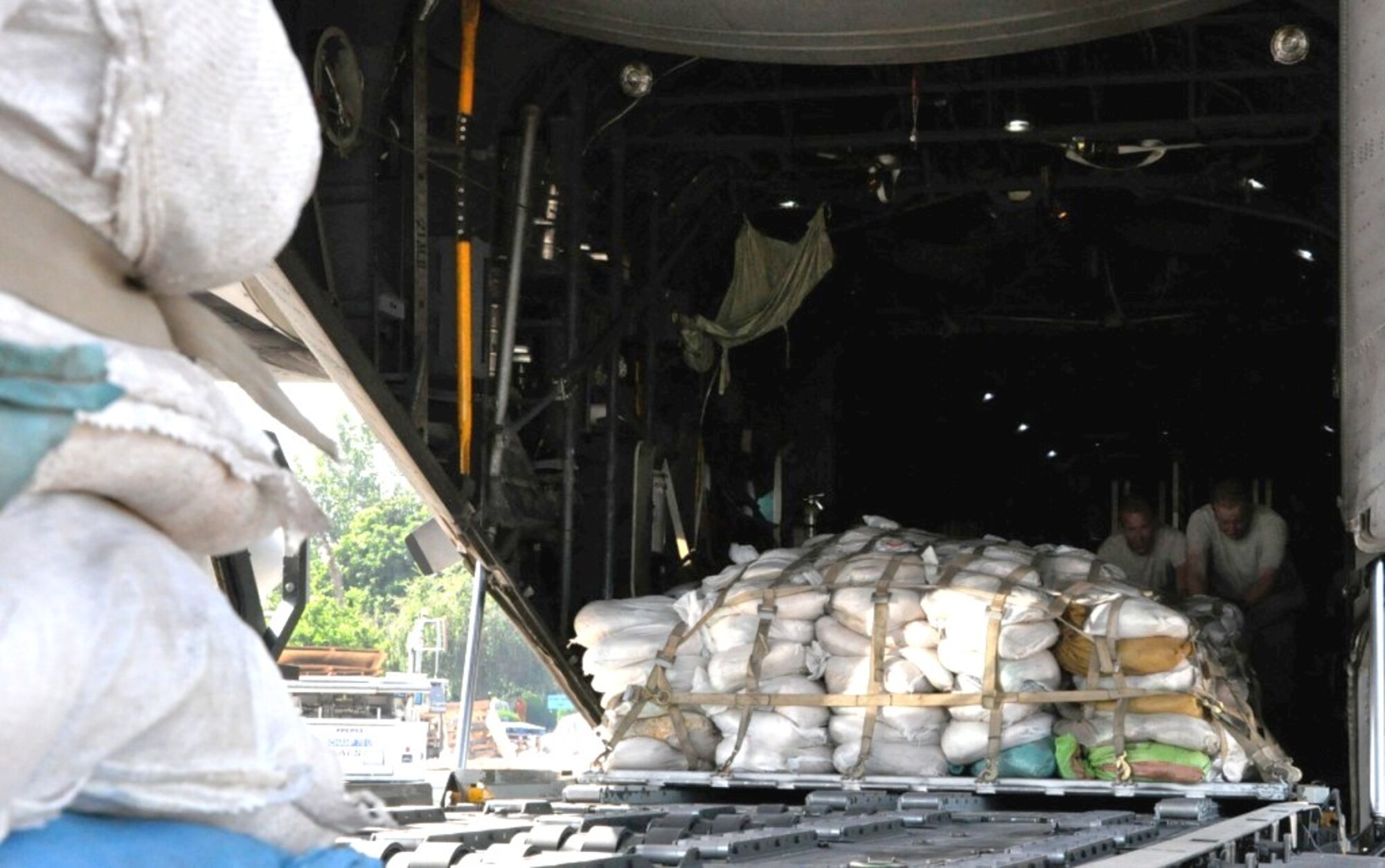 CHAKLALA, PAKISTAN -- Members of the U.S. Air Force contingency response element in Pakistan aid a U.S. Air Force C-130 Hercules loadmaster with offloading pallets of flood relief supplies Sept. 20 at Pakistan Air Force Base Chaklala. The CRE deployed from the 621st Contingency Response Wing, Joint Base McGuire-Dix-Lakehurst, N.J., to augment operations at the Pakistan Air Force's Central Flood Relief Cell at the air base. To date, U.S. military personnel and aircraft, working in partnership with the Pakistan military, have delivered more than 3.8 million kilograms of relief supplies and rescued more than 16,000 people throughout the flood-stricken areas of Pakistan. (U.S. Air Force photo/Staff Sgt. Kali
L. Gradishar)
