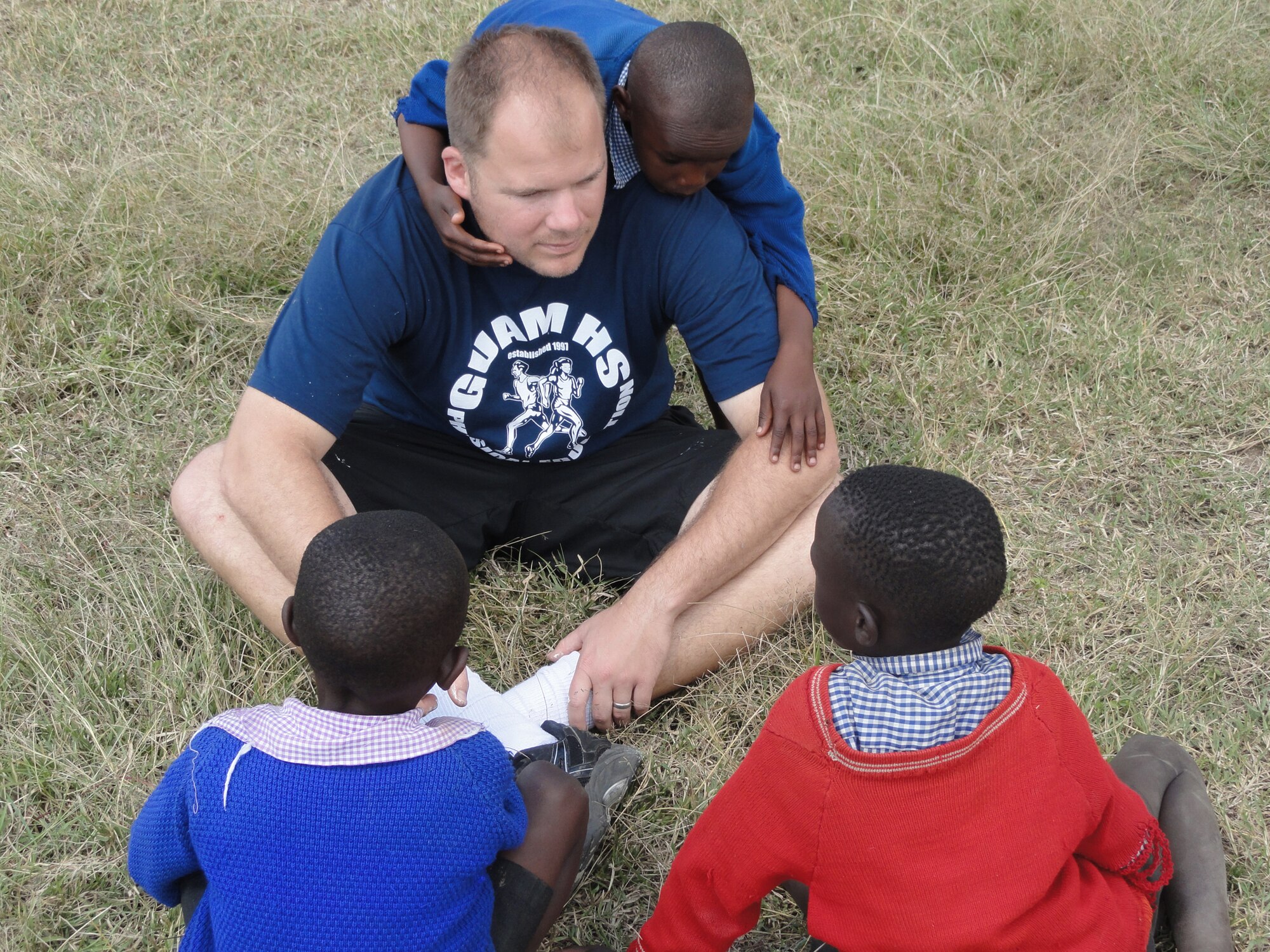 Maj. Jonathan Gration plays with children at the Hope for Life Orphanage in Nakuru, Kenya. Major Gration and his wife, Capt. Julie Gration, raised money to donate solar cookers to the women of Abu Shouk camp in Sudan and traveled to Kenya to complete a service project at Hope for Life, an orphanage for children who have lost their parents to AIDS. Major Gration is assigned to the 90th Fighter Squadron and Captain Gration is a Reservist assigned to the 477th Fighter Group, both at Joint Base Elmendorf-Richardson, Alaska. (Courtesy Photo)