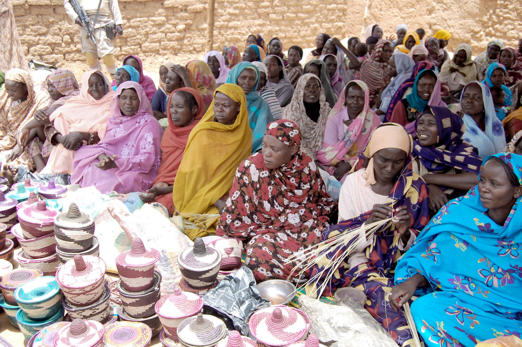 The women of the Abu Shouk camp came out to celebrate receiving solar cookers donated by Maj. Jonathan Gration. Using the solar cookers cuts the requirement for firewood by two-thirds, keeps the women from having to search for firewood outside of the camp where they are at risk for attack and preserves Darfur's trees, which currently ranks fourth in the world for deforestation. Major Gration is a pilot assigned to the 90th Fighter Squadron at Joint Base Elmendorf-Richardson, Alaska. (Courtesy Photo)