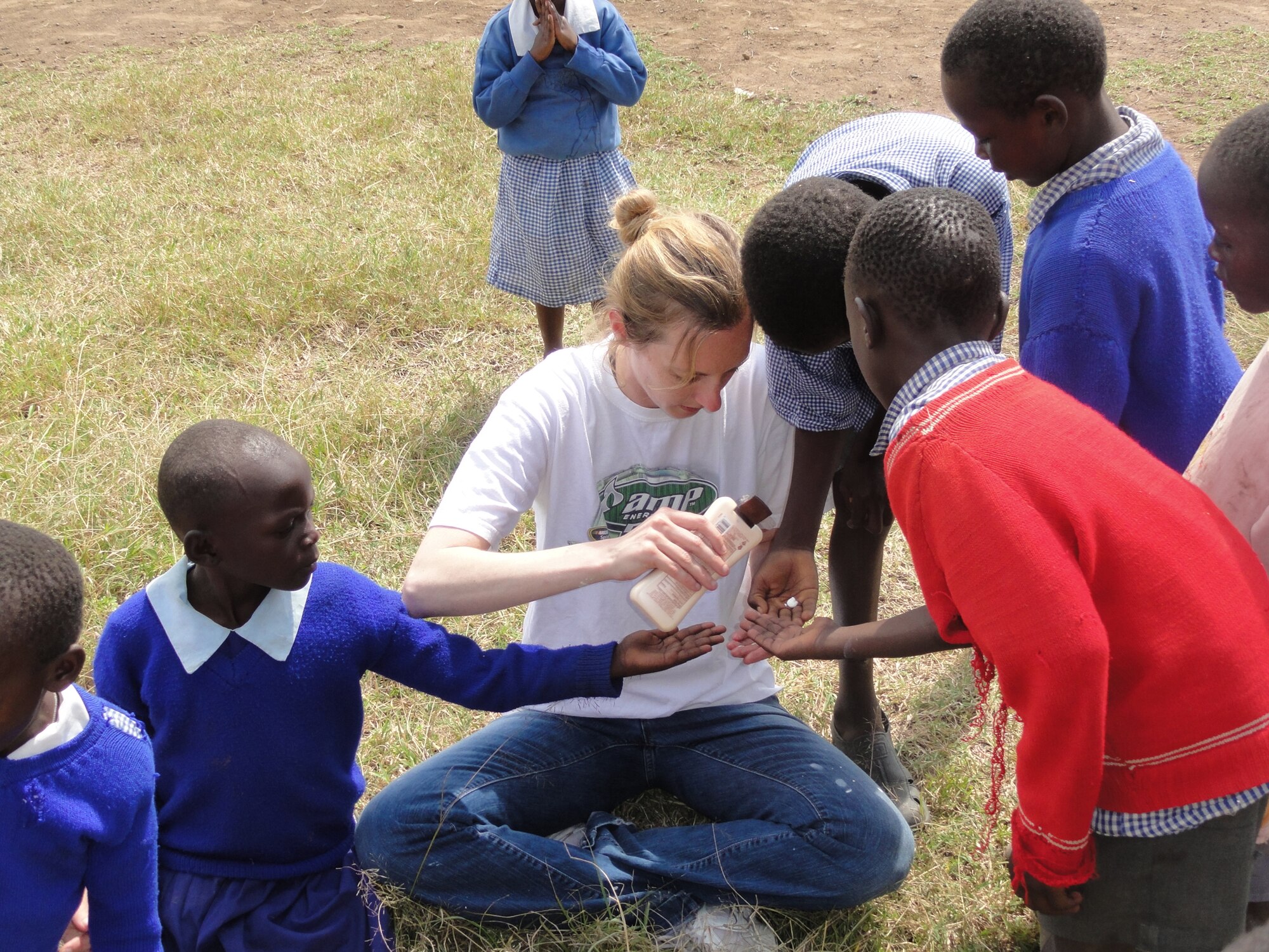 Capt. Julie Gration takes a break from completing renovations on a schoolroom to play with some of the children at the Hope for Life Orphanage in Nakuru, Kenya. Hope for Life is an orphanage for children who have lost parents to AIDS. Captain Graion is a Reservist with the 477th Fighter Group. Captain Gration is assigned to the 477th Fighter Group at Joint Base Elmendorf-Richardson, Alaska.  (Courtesy Photo)