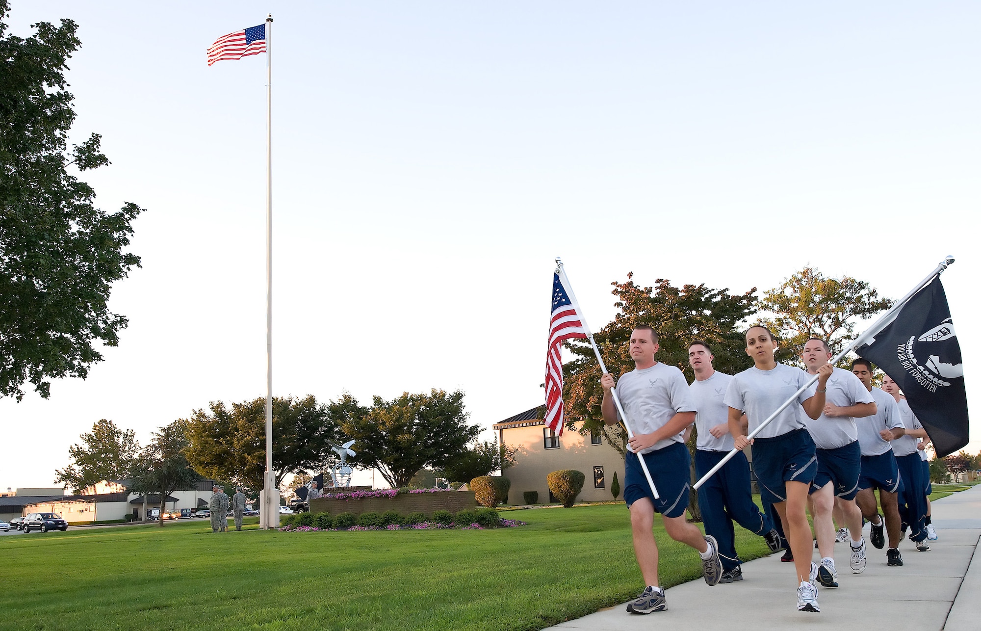 Team Dover members run in formation as they participate in the 24 hour Prisoner of War and Missing in Action Remembrance Run on Dover Air Force Base, Del., Sept. 17, 2010. The participants of the run ran with both the United States and POW flag, as a reminder of those who have still not returned home. (U.S.  Air Force photo by Roland Balik/Released)