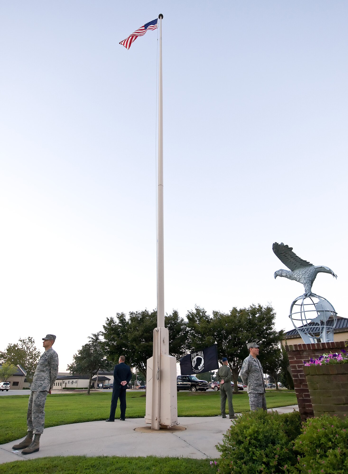Team Dover members stand silent watch during the Prisoner of War and Missing in Action Vigil at the flagpole outside the 436th Airlift Wing headquarters building on Dover Air Force Base, Del., Sept. 17, 2010. The event started at reveille that morning, and ended with a ceremony that was followed by retreat. All the members of the vigil volunteered their time to stand watch for their brothers and sisters in arms who had yet to return home. (U.S.  Air Force photo by Roland Balik/Released)