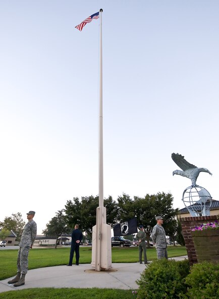 Team Dover members stand silent watch during the Prisoner of War and Missing in Action Vigil at the flagpole outside the 436th Airlift Wing headquarters building on Dover Air Force Base, Del., on Sept. 17, 2010. The event started at reveille that morning, and ended with a ceremony that was followed by retreat. All the members of the vigil volunteered their time to stand watch for their brothers and sisters in arms who had yet to return home. (U.S. Air Force Photo/Roland Balik) 