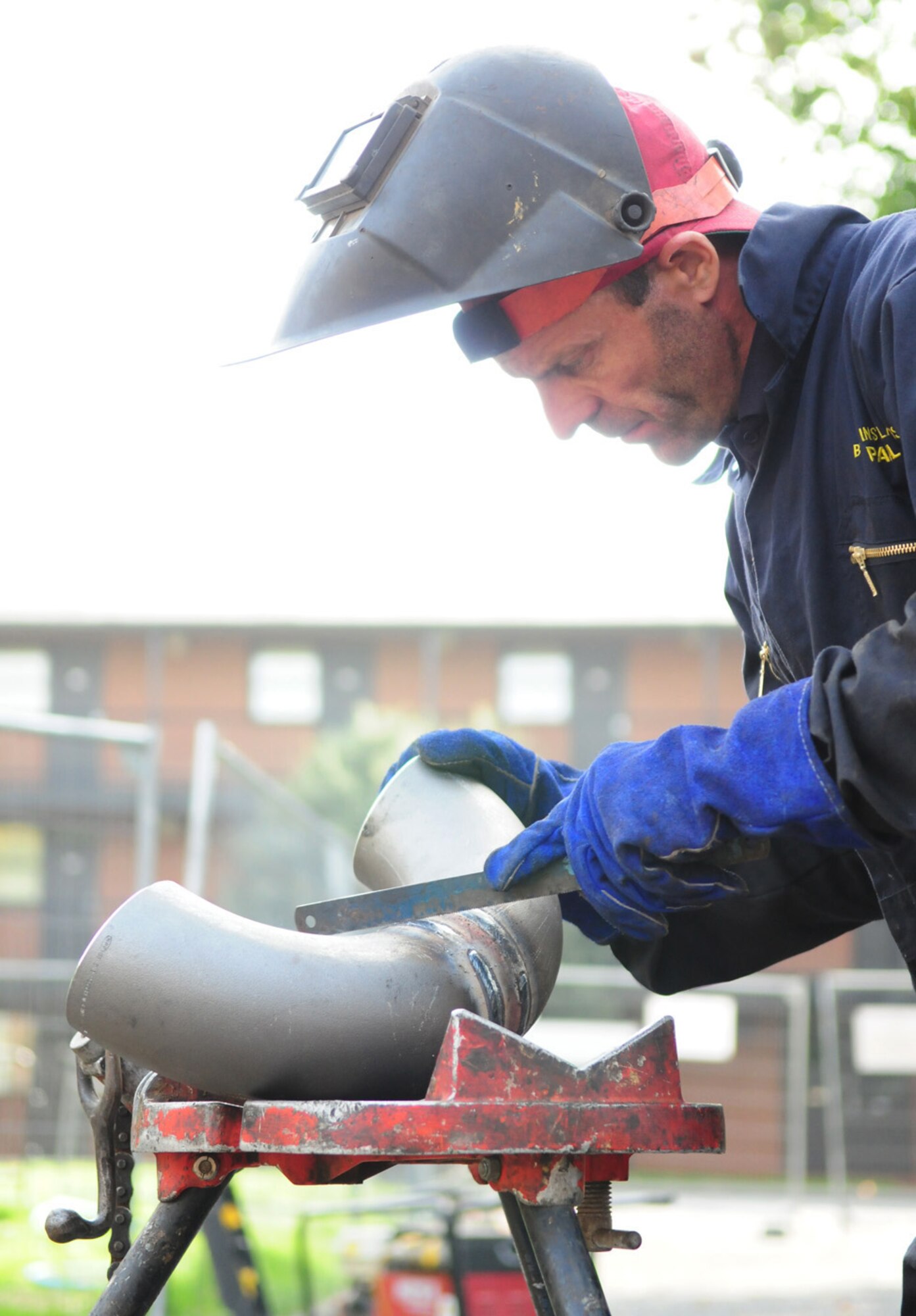 RAF MILDENHALL, England -- Paul Blackbird, a local contractor, prepares a 6-inch metal U-bend pipe for welding here Sept. 22. The metal pipe is used to link the district heating main to complete a circuit back to the boiler house, from a former dormitory that is currently being demolished. (U.S. Air Force photo/Karen Abeyasekere)