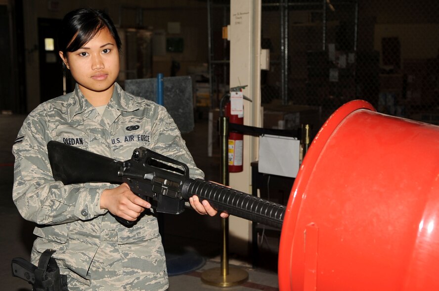 Airman 1st Class Joann Oledan, 319th Logistics Readiness Squadron, poses for a photo while executing proper weapon clearing procedures Sept. 22 on Grand Forks Air Force Base, N.D. (U.S. Air Force photo by Senior Airman Amanda N. Stencil)