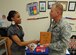 Aepril Smith receives the Air Force Services Youth of the Year award for 2010 from 628th Mission Support Group Commander Col. Ben Wham at the Youth Programs Center Sept. 17, 2010, on Joint Base Charleston, S.C. The Youth of the Year program recognizes young people for their contribution to their families, youth programs, schools and communities. Aepril is a high school senior at Wando High School and plans to attend Duke University upon graduation. (U.S. Air Force photo/Senior Airman Timothy Taylor)