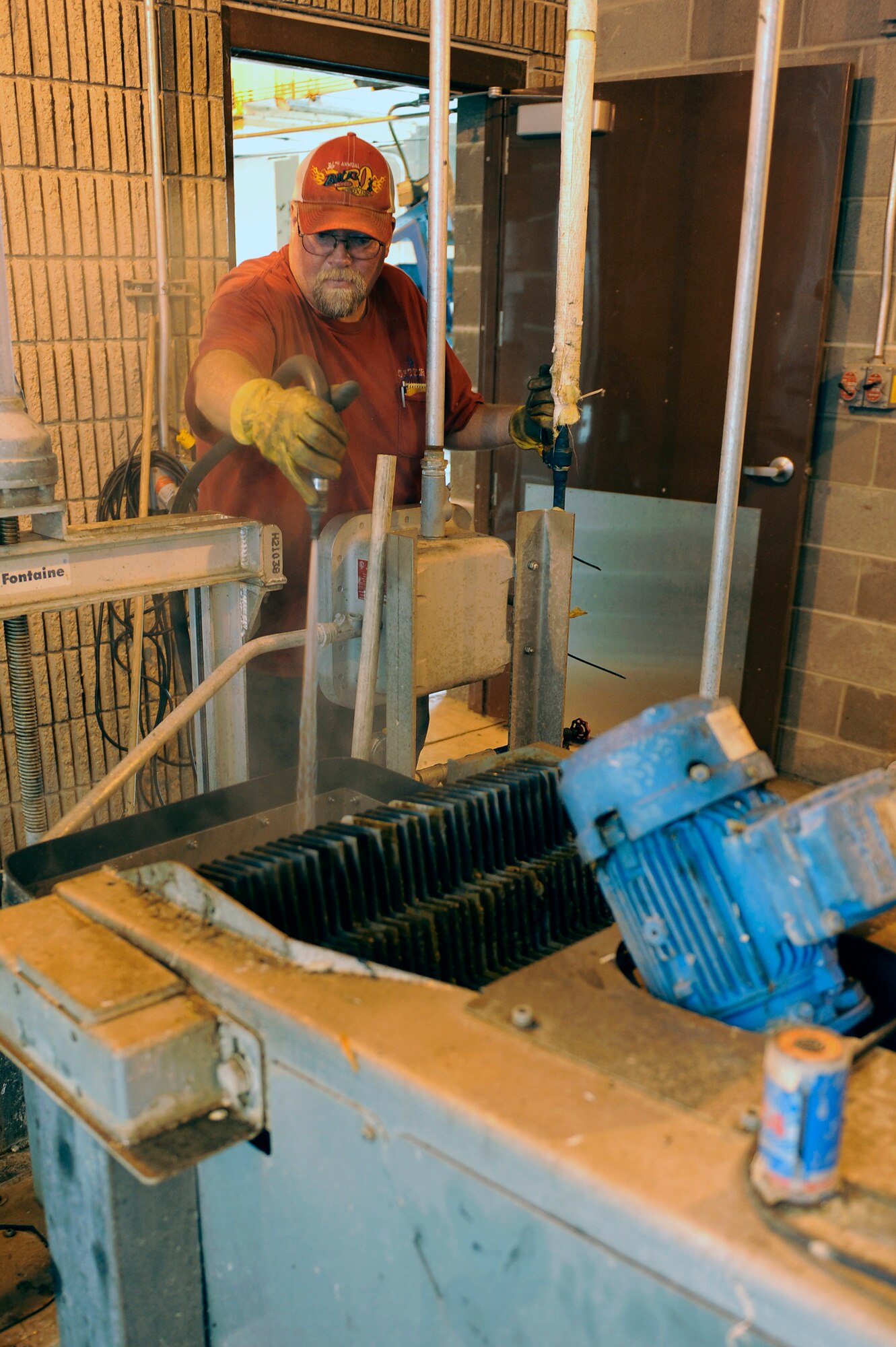 ELLSWORTH AIR FORCE BASE, S.D. - Carl Johnson, plant operator, cleans a step screen used to remove floating solids from waste water, Sept. 15.  The Ellsworth waste water treatment facility treats approximately 800,000 gallons of water a day. (U.S. Air Force photo/Staff Sgt. Marc I. Lane)