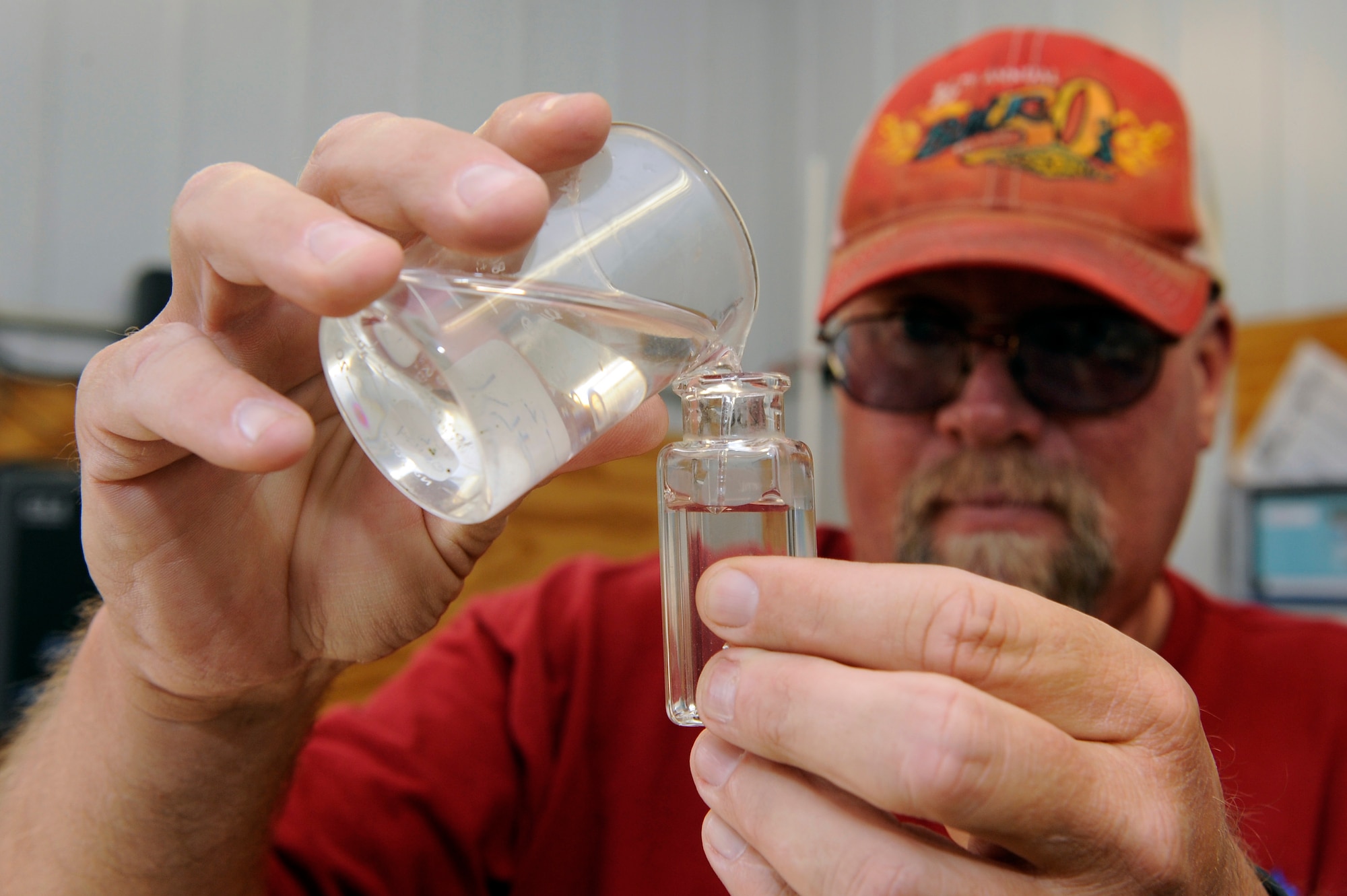 ELLSWORTH AIR FORCE BASE, S.D. - Carl Johnson, plant operator, pours effluent water into a test container at the waste water treatment facility, Sept. 15.  The effluent water is tested for chlorine levels to ensure the water is properly treated.  The chlorine is removed before the water leaves the facility. (U.S. Air Force photo/Staff Sgt. Marc I. Lane)