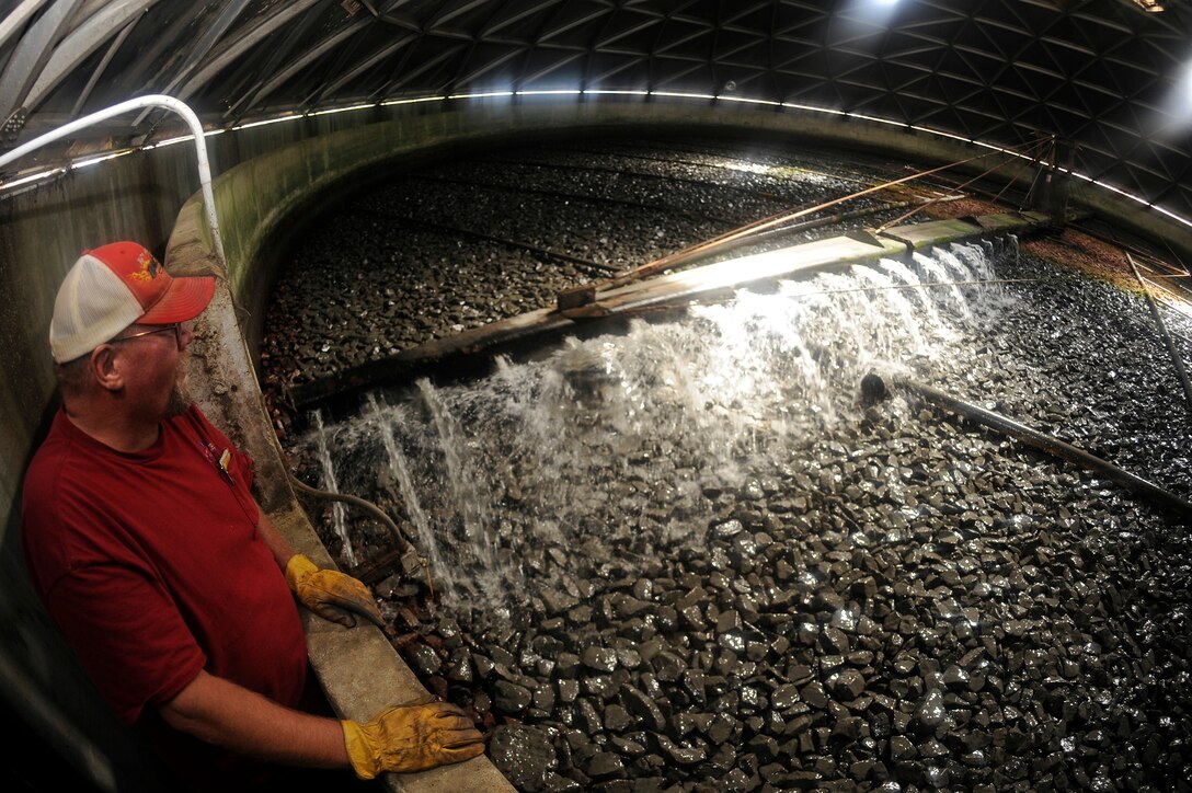 ELLSWORTH AIR FORCE BASE, S.D. - Carl Johnson, plant operator, observes the trickling filter at the waste water treatment facility, Sept. 15.  The trickling filter functions by pouring waste water over a bed of rocks covered with microbiological bacteria slime which removes waste from the water, naturally. (U.S. Air Force photo/Staff Sgt. Marc I. Lane)